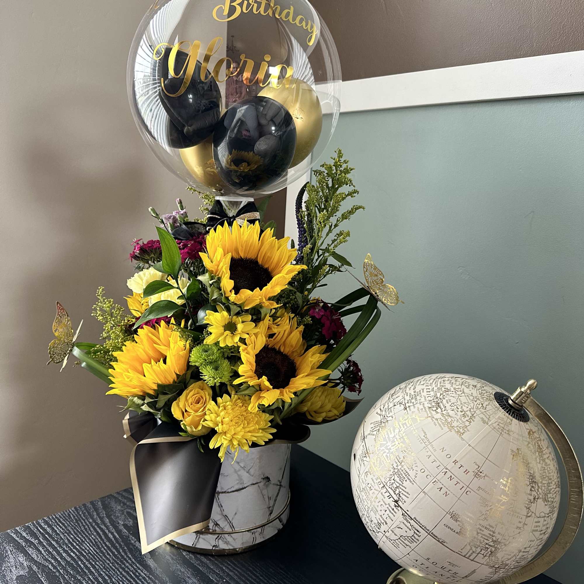 A bold and cheerful arrangement featuring radiant sunflowers, beautifully complemented by a