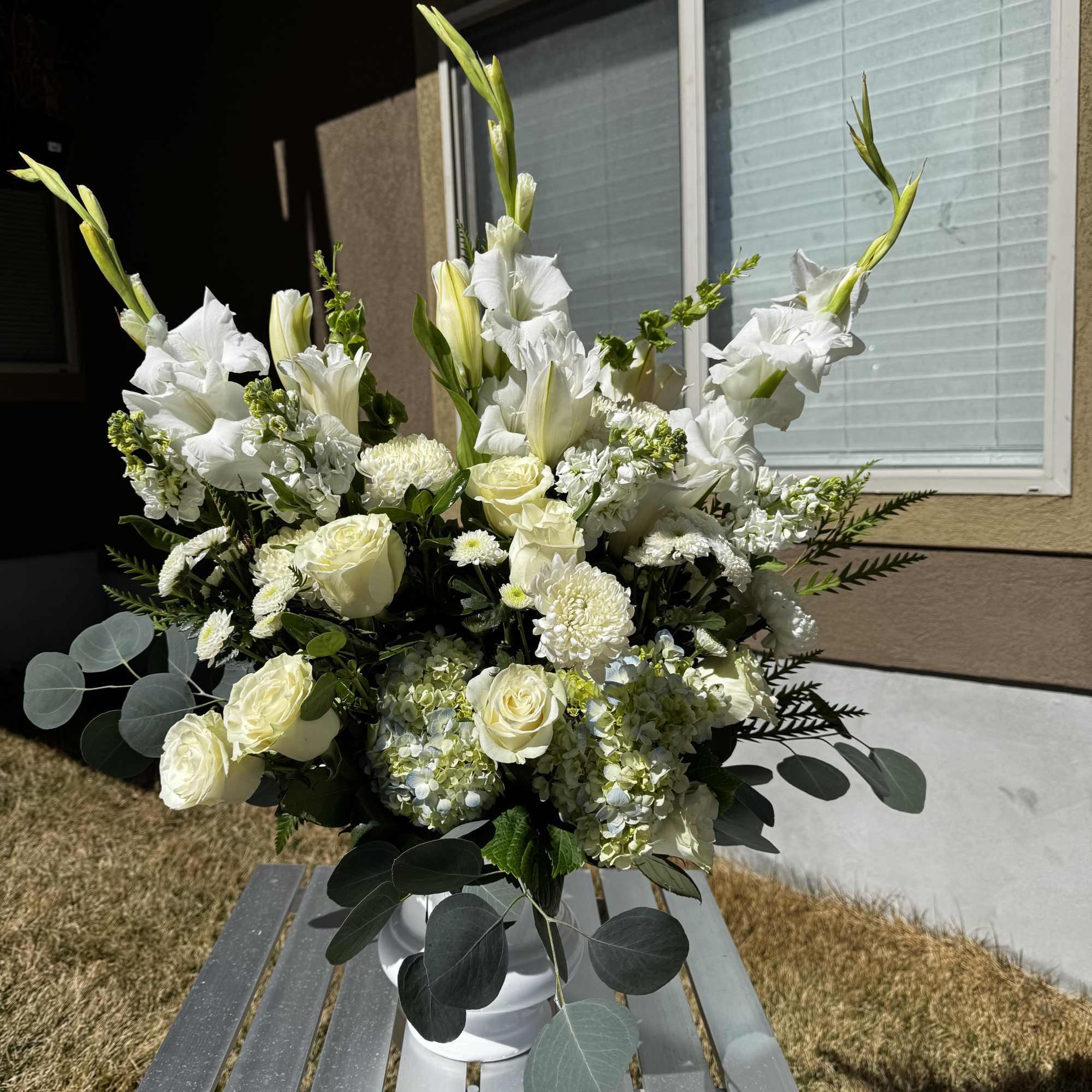 Convey your deepest sentiments with our Peaceful Grace Arrangement, a sophisticated display