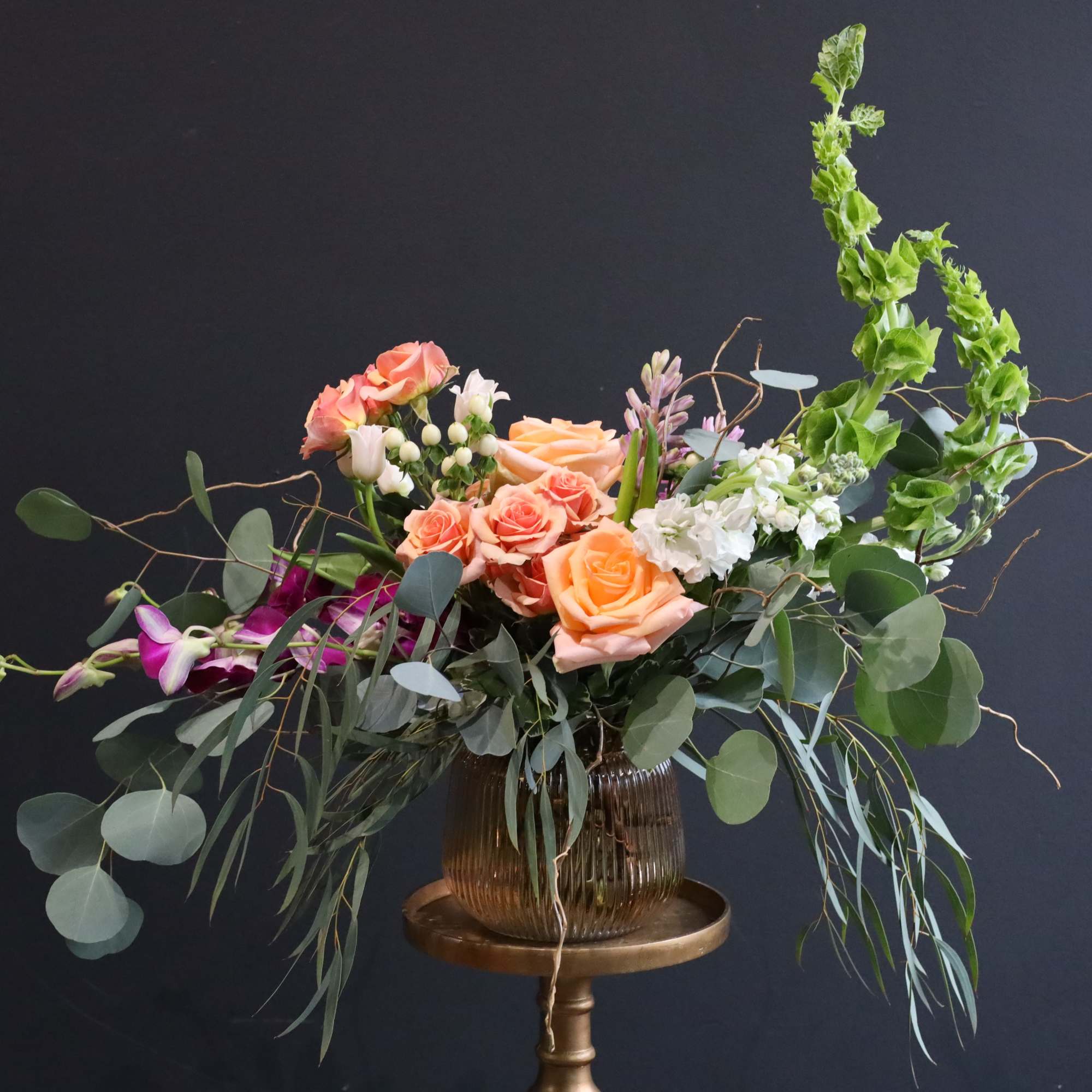 An arrangement artistically flowing with a variety of premium stems in a