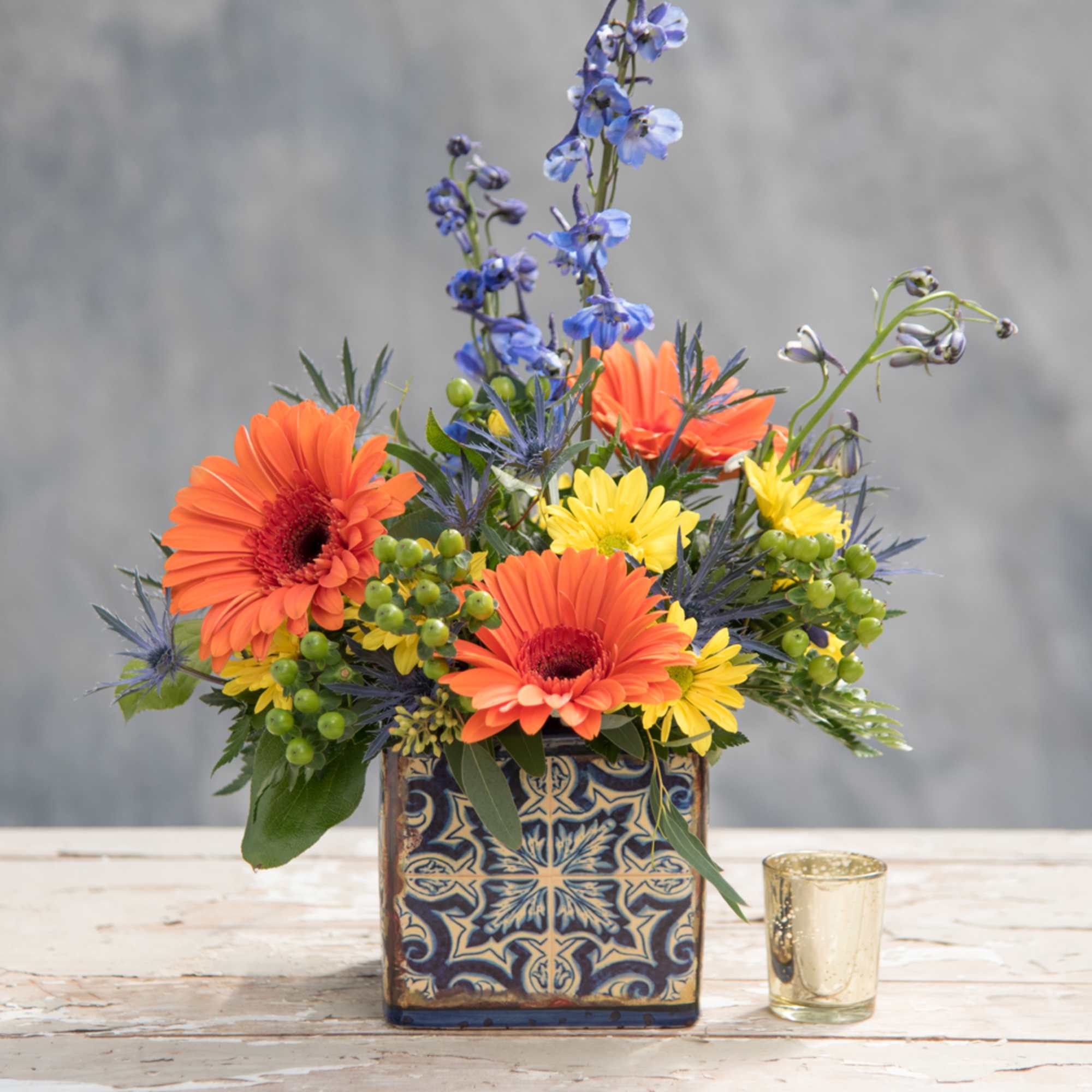 Fresh blue and orange  blooms including delphinium and gerber daisies look Fresh blue and orange  blooms including delphinium and gerber daisies look