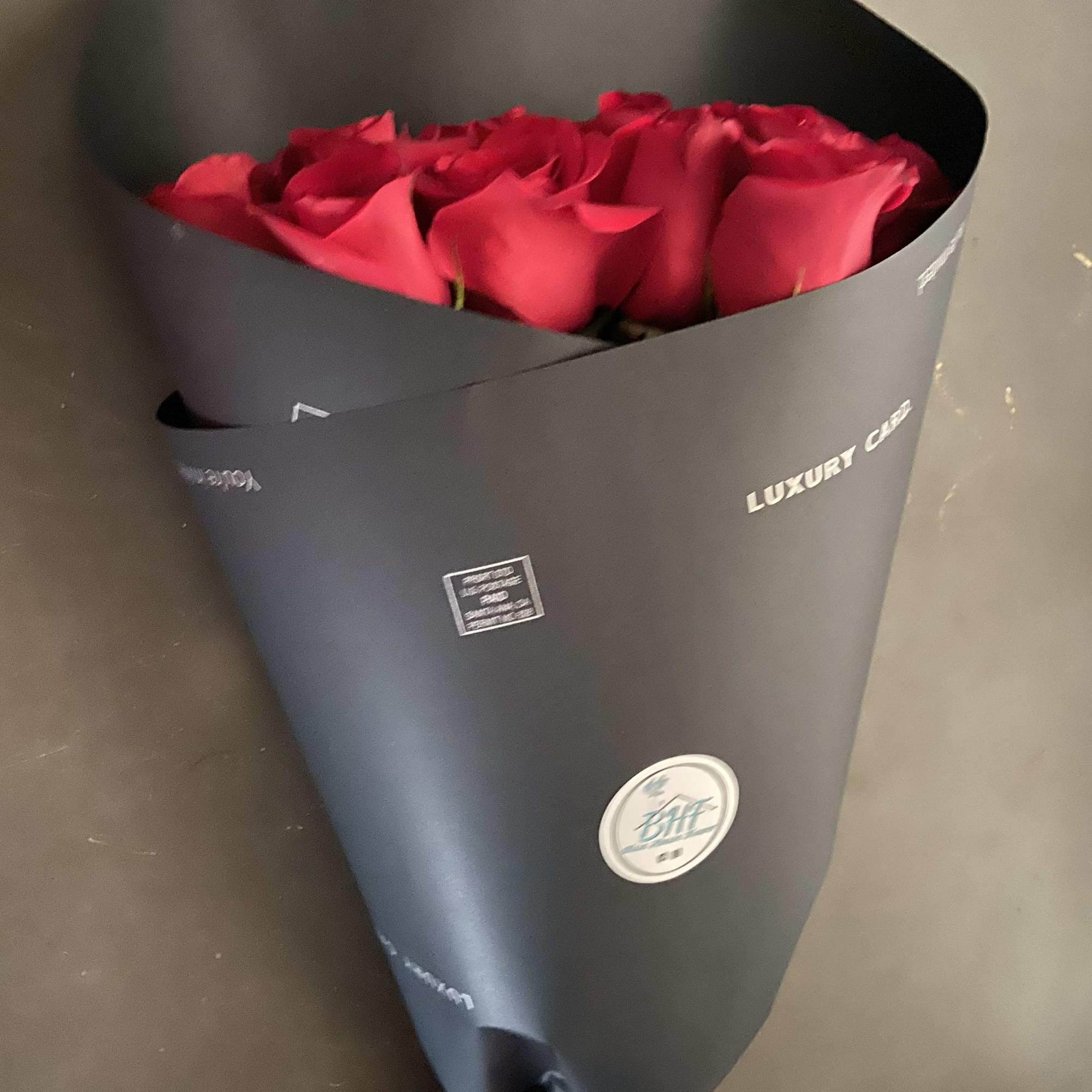 24 Red Roses, wrapped with Black paper, with Red Ribbon