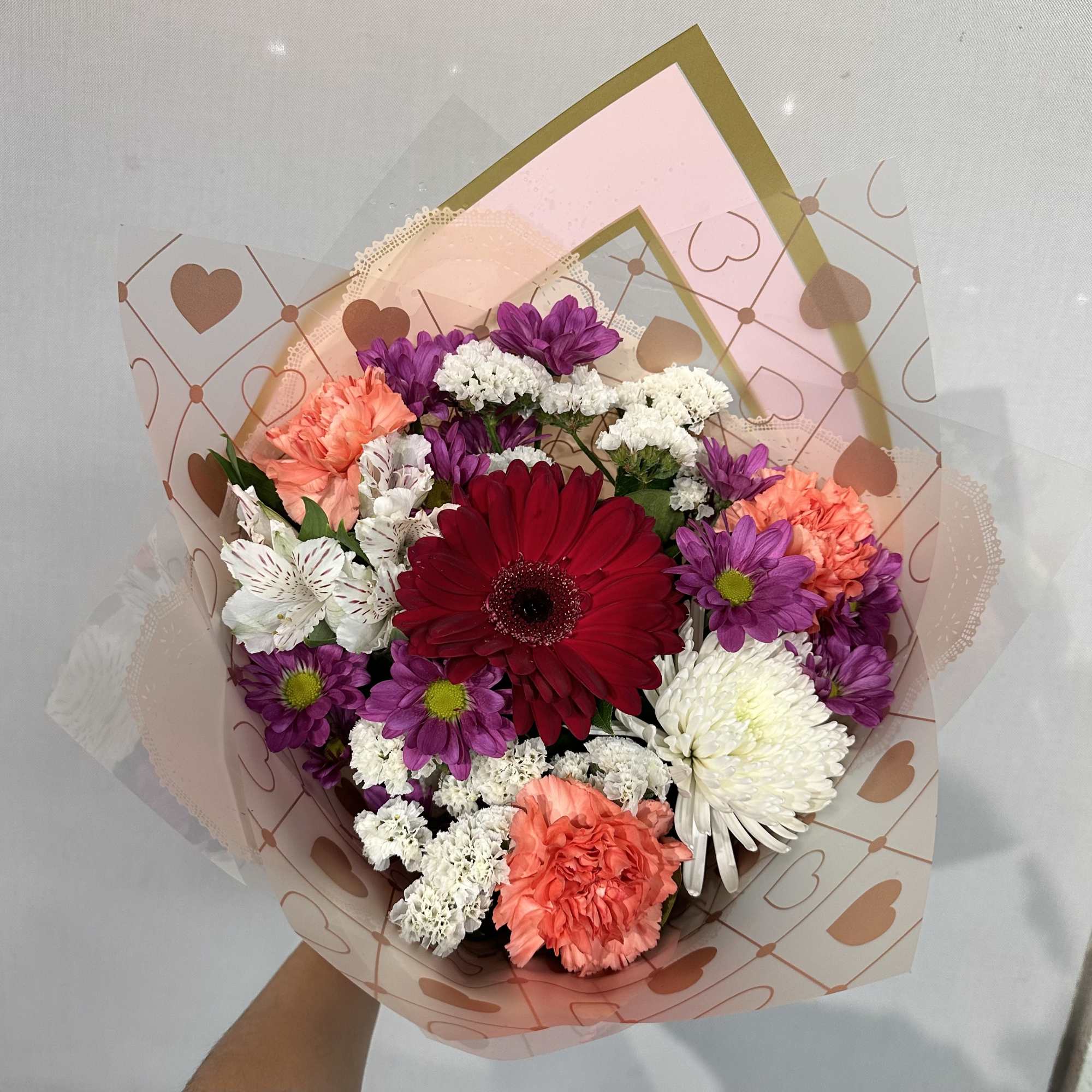 Hand held bouquet with our freshest mix florals. A bright colorful bouquet