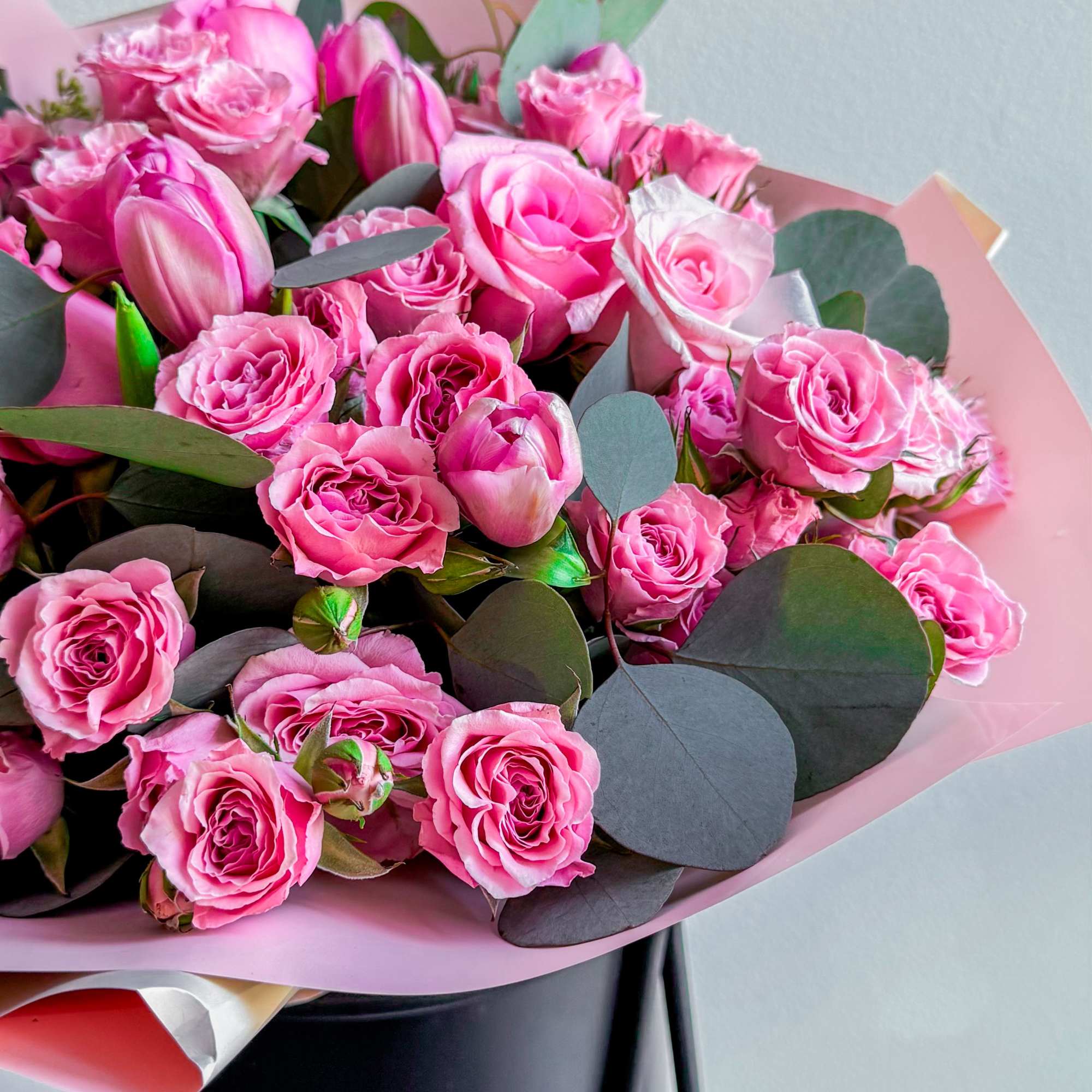 The bouquet includes bright pink roses of different shades and sizes, and The bouquet includes bright pink roses of different shades and sizes, and
