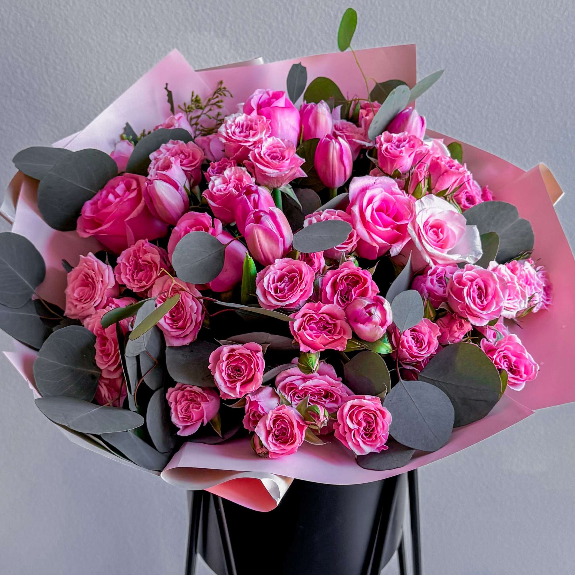 The bouquet includes bright pink roses of different shades and sizes, and The bouquet includes bright pink roses of different shades and sizes, and