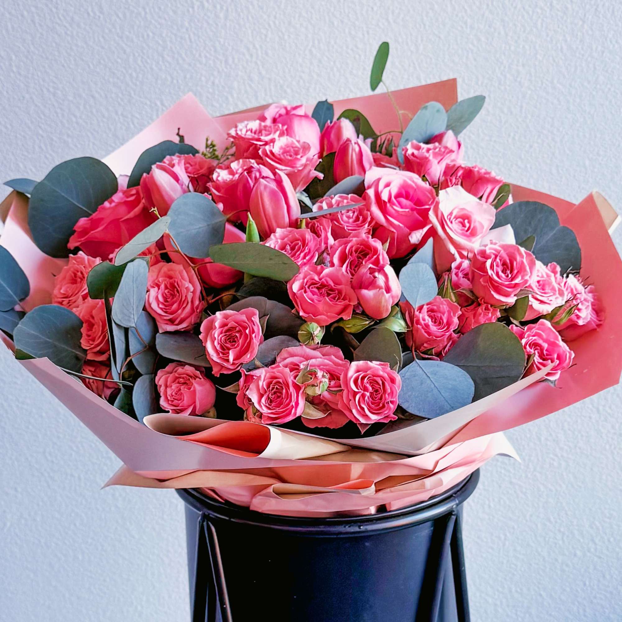 The bouquet includes bright pink roses of different shades and sizes, and The bouquet includes bright pink roses of different shades and sizes, and