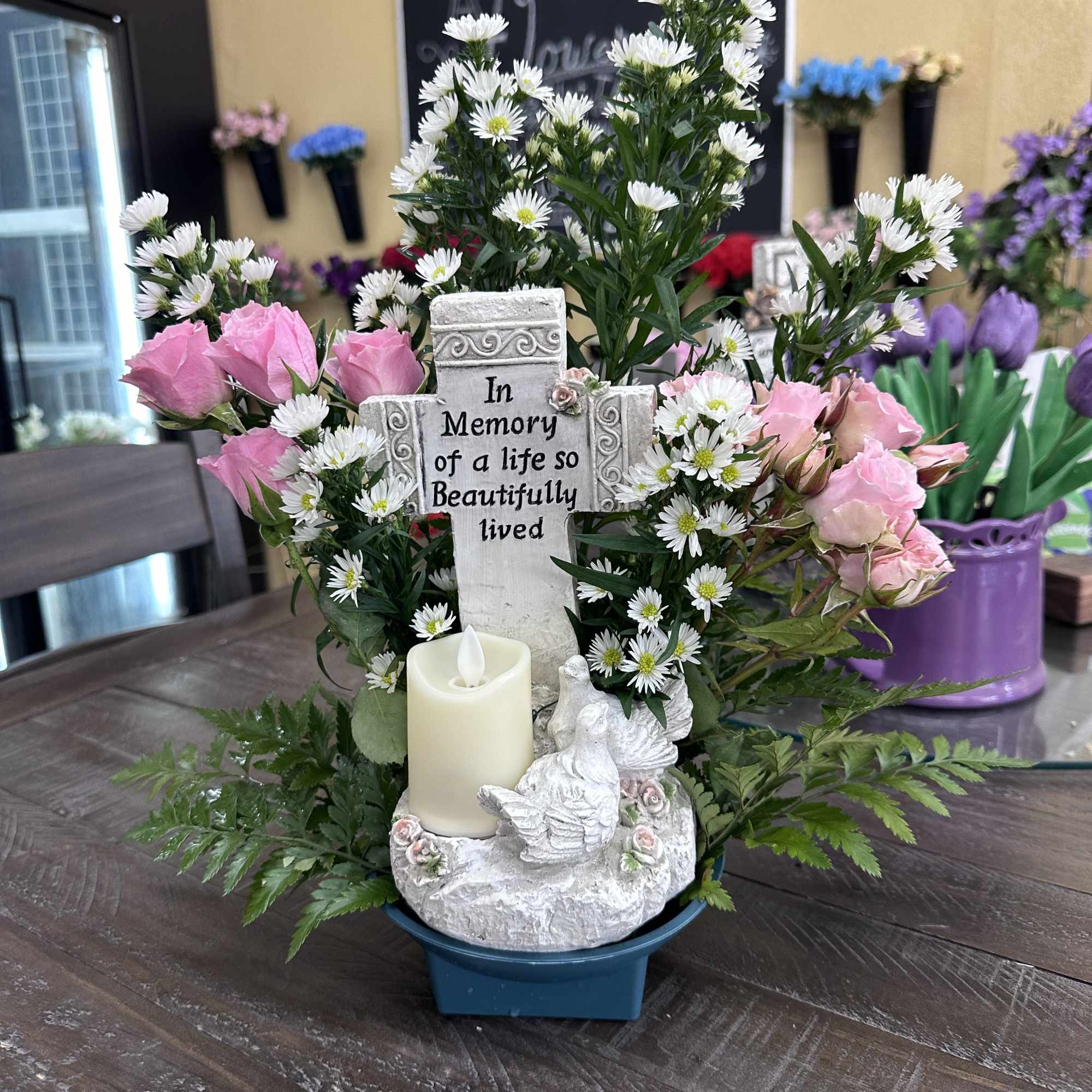 Cross with candle and birds "In memory of a life beautifully lived"