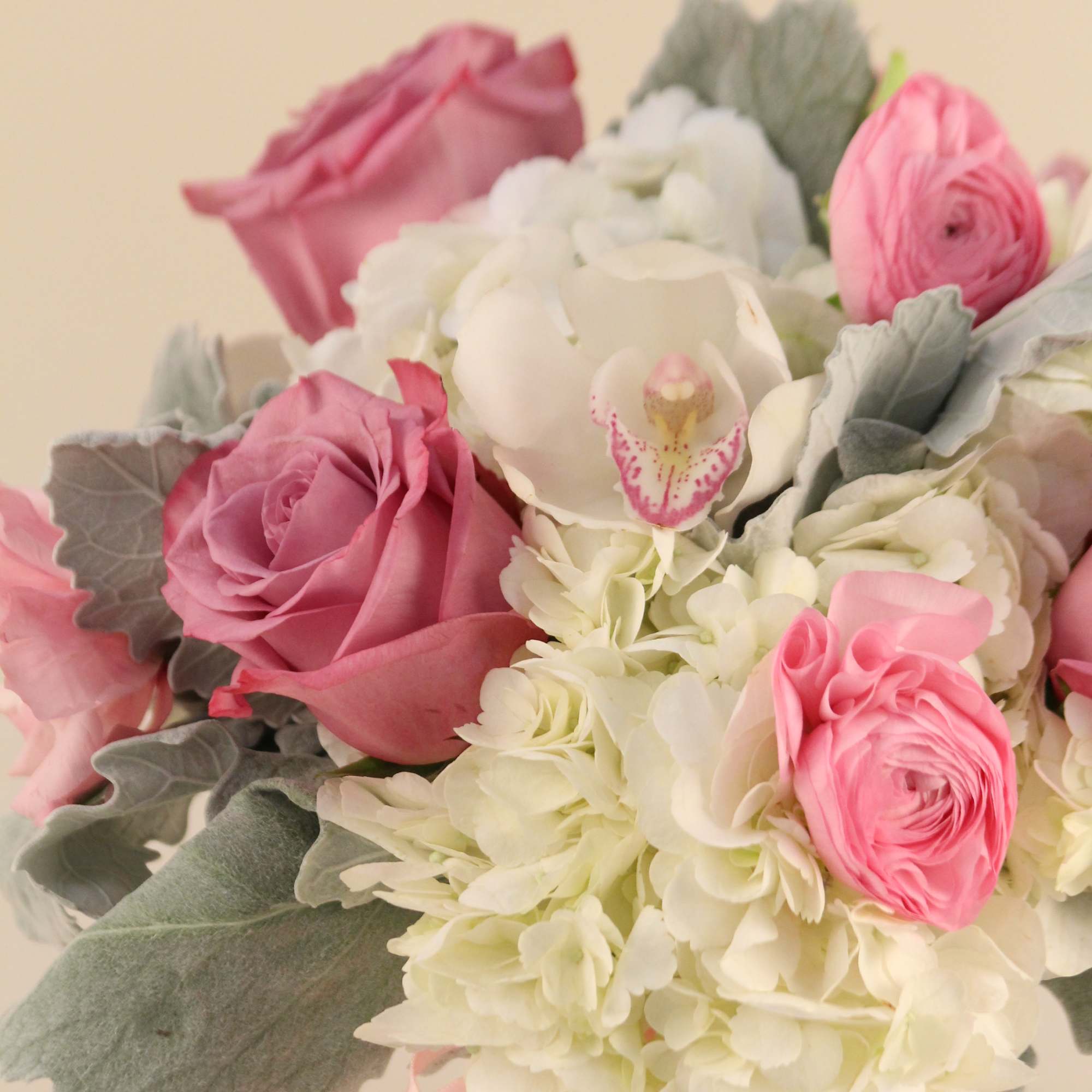 Mix of blush and lavender blooms in a white hobnail vase. May