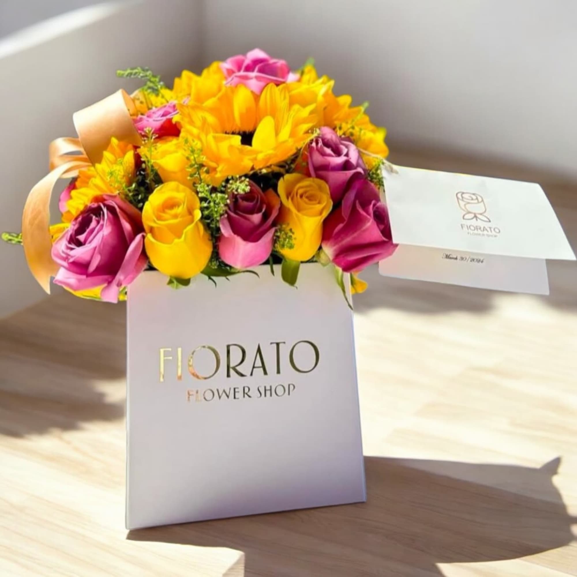 A radiant, joyful floral arrangement featuring bold lavender, vibrant yellow, and golden