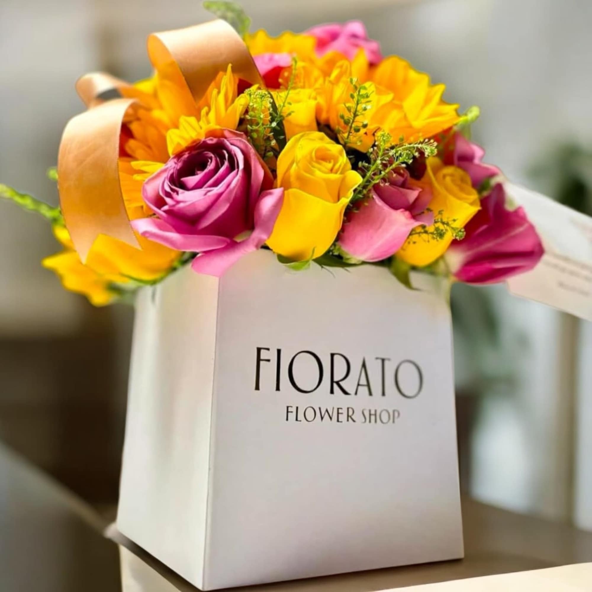 A radiant, joyful floral arrangement featuring bold lavender, vibrant yellow, and golden