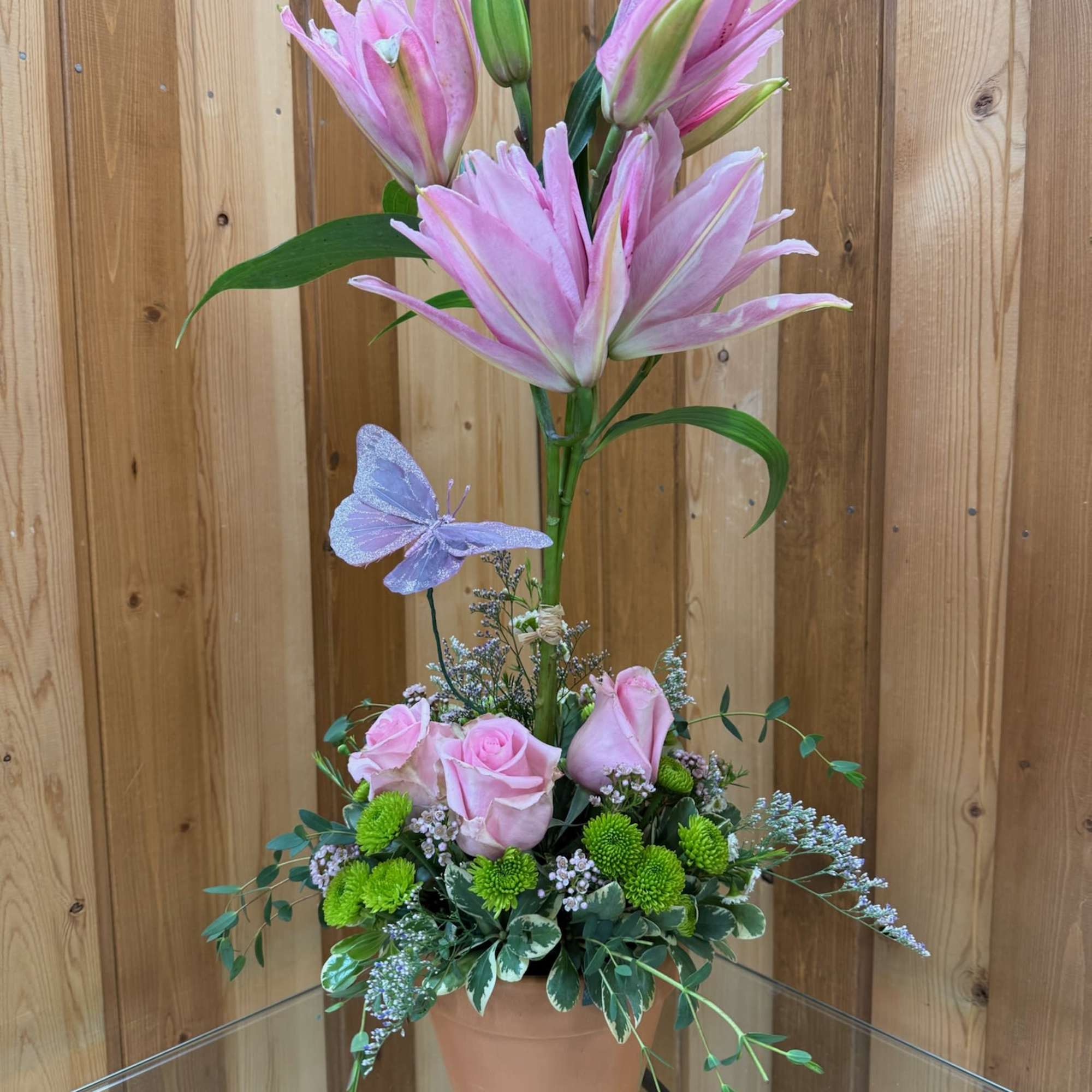 Bright  lilies are uniquely arranged into a topiary and grounded  Bright  lilies are uniquely arranged into a topiary and grounded