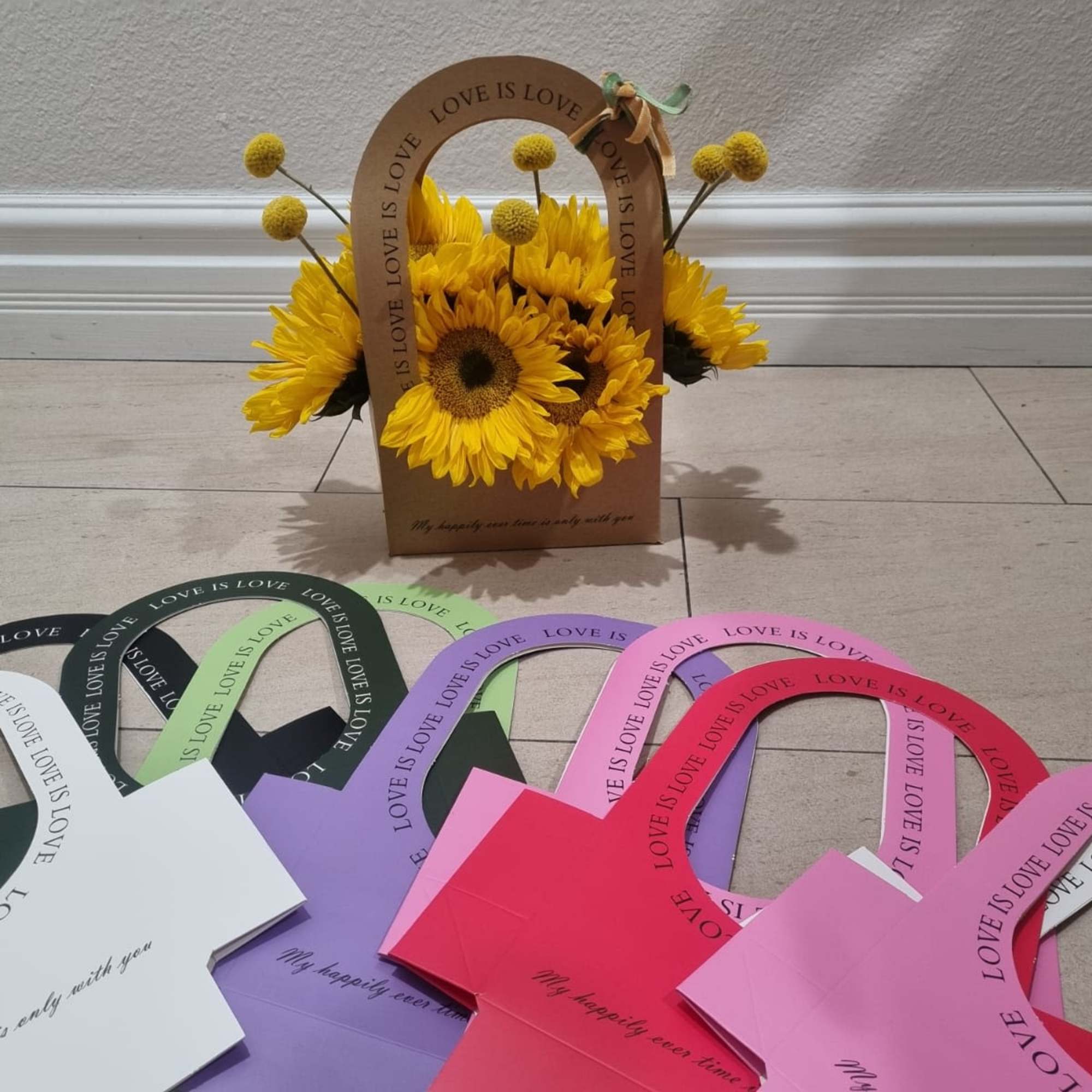 Nestled in charming kraft tote that reads love is love, this floral