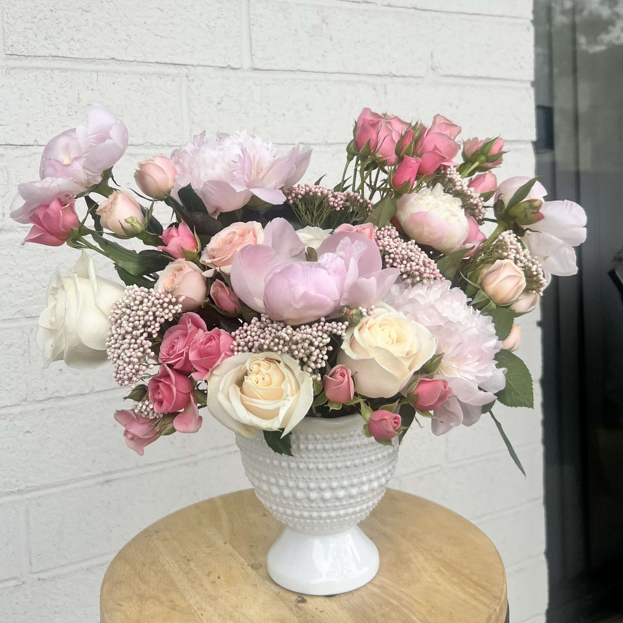 A lush Garden Style arrangement crafted on floral foam, capturing the elegance
