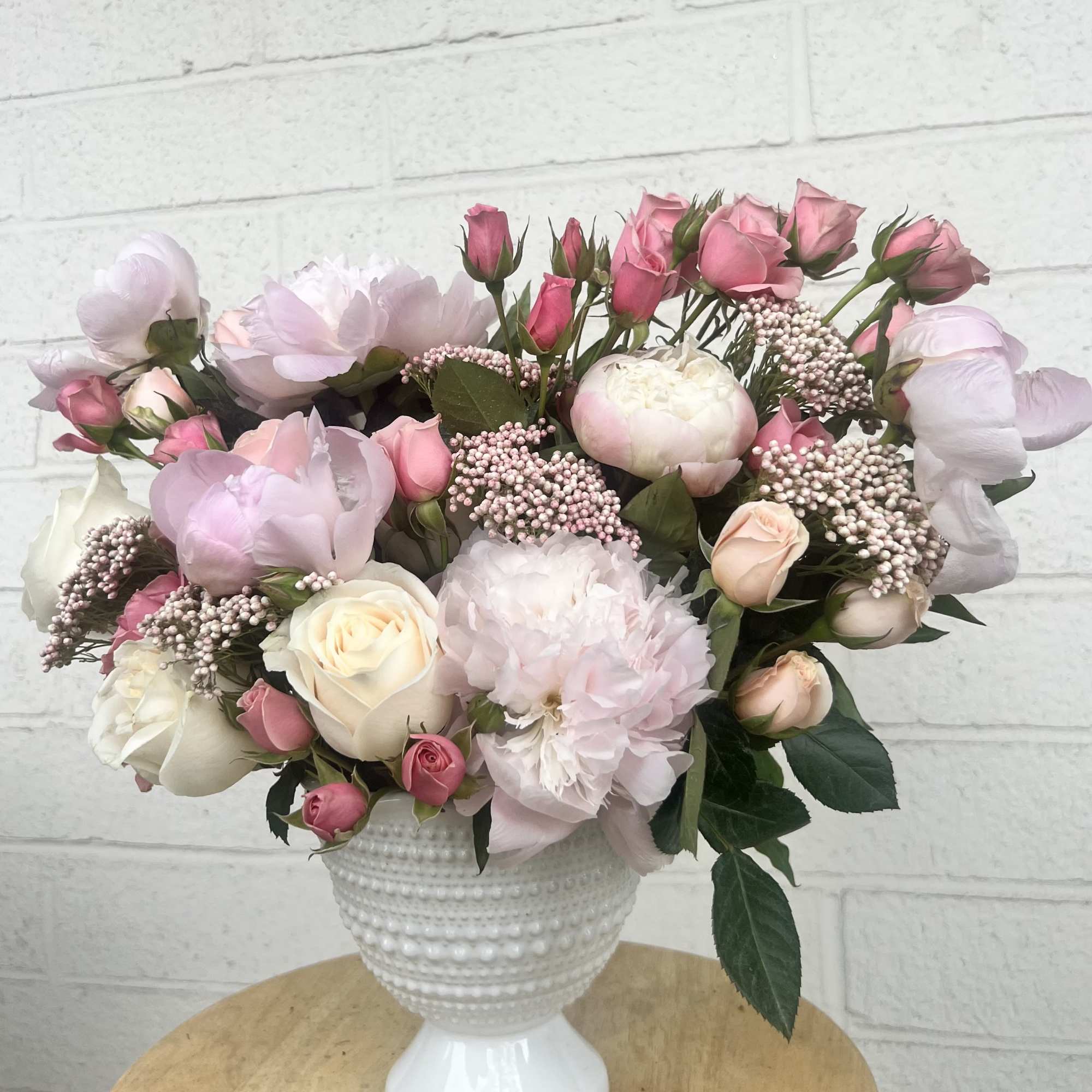 A lush Garden Style arrangement crafted on floral foam, capturing the elegance