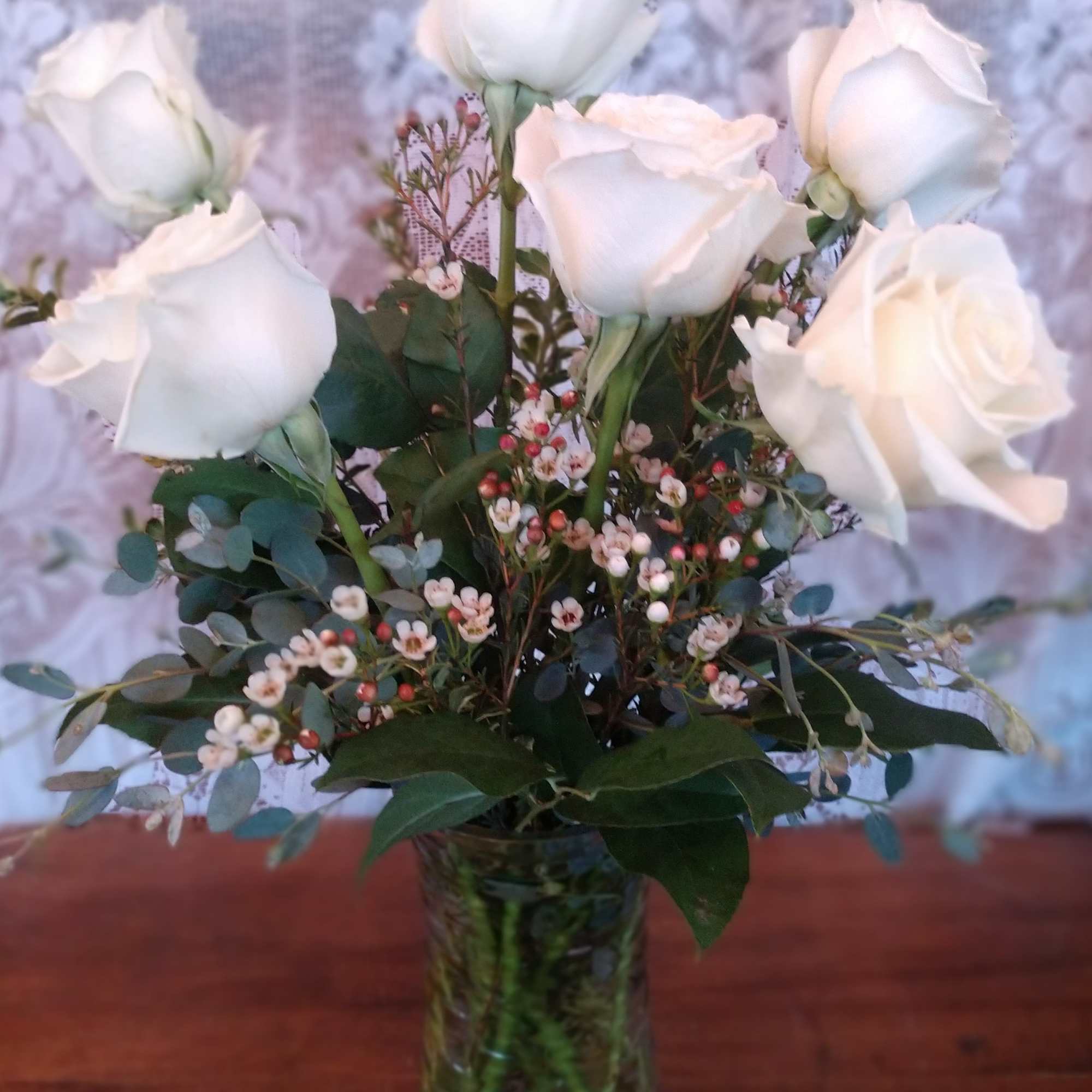 Premium white roses arranged in a glass vase.  Premium white roses arranged in a glass vase.