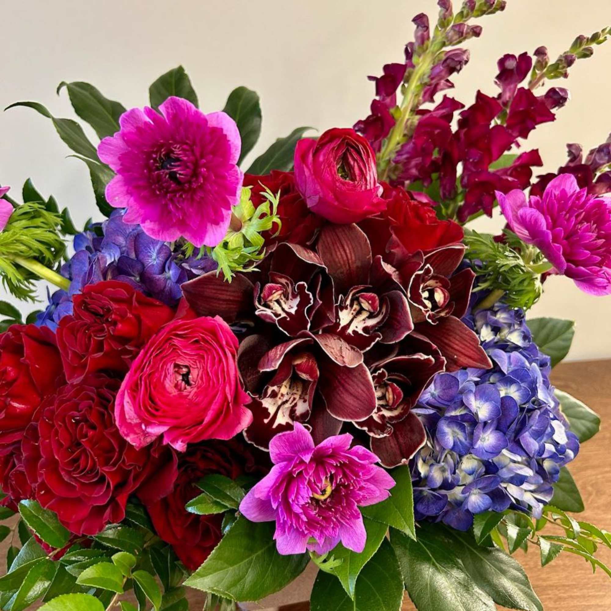 Treat the Goddess in your life to this sultry, moody arrangement. Contains