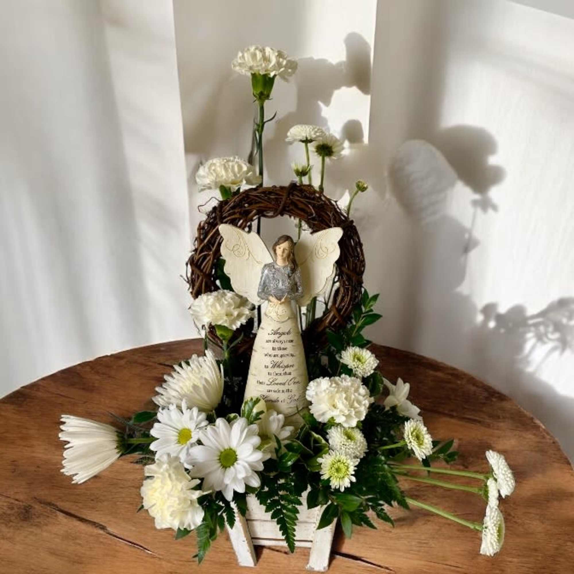 Heavenly Angel Memorial Arrangement
 A gentle tribute for a cherished soul

Honor a