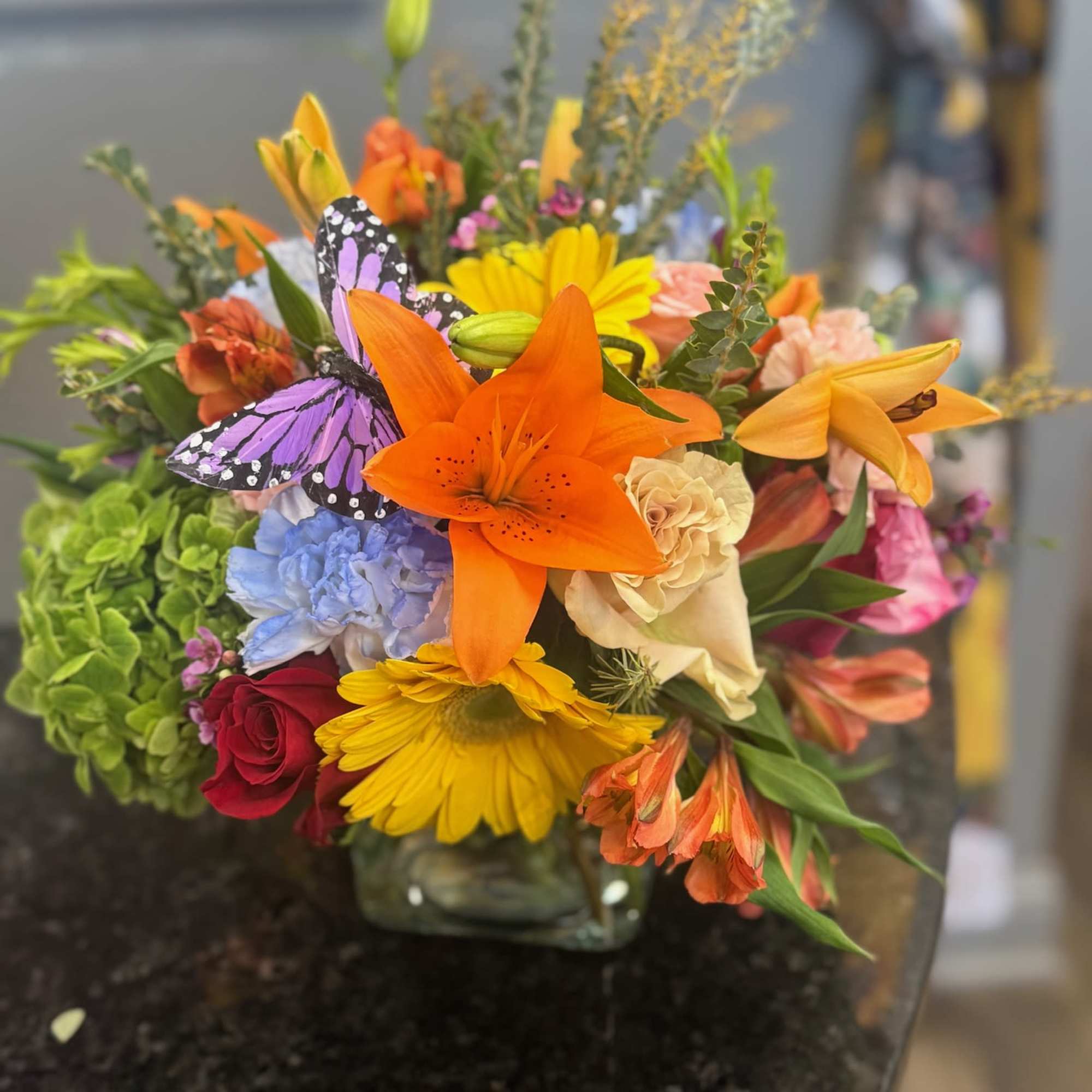 Seasonal flowers designed in vase with greenery and filler.  Seasonal flowers designed in vase with greenery and filler.