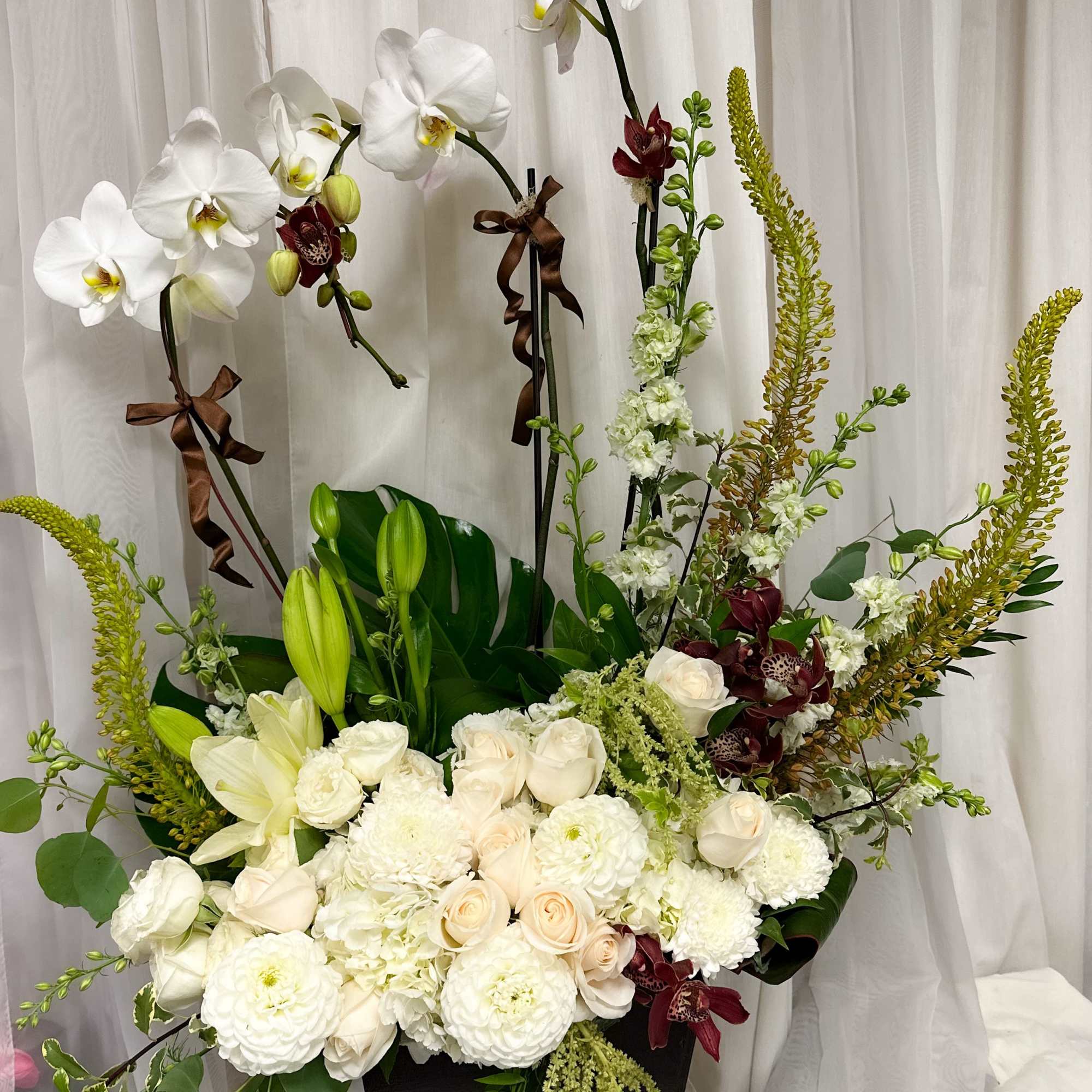 Understated luxury meets natural elegance in Whispering Orchids &mdash; a stunning arrangement