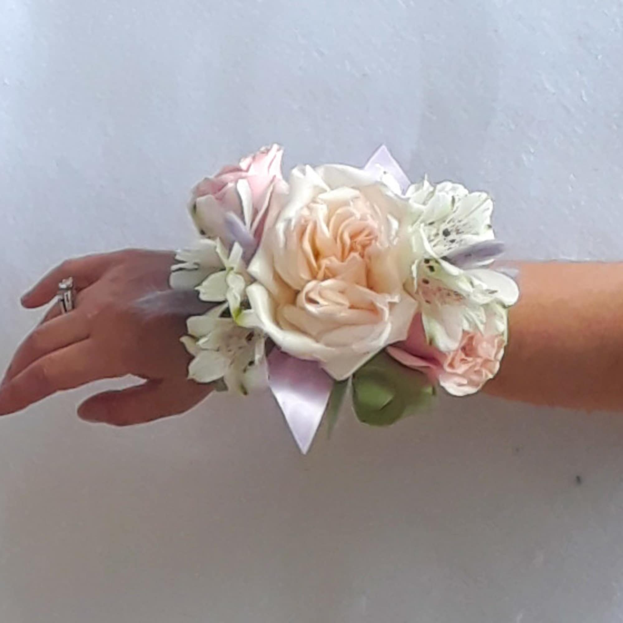 Lovely roses and orchids arranged for the wrist. All fresh flower designs