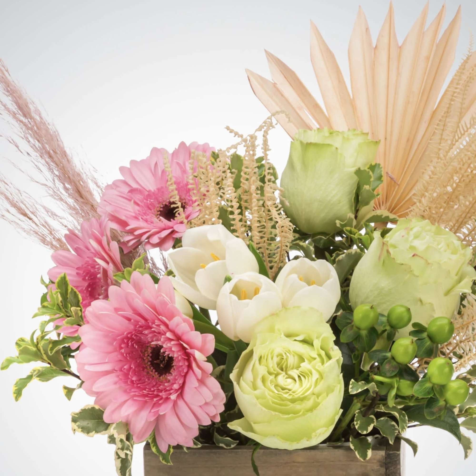 A boho arrangement featuring an eclectic mix of flowers and textures that
