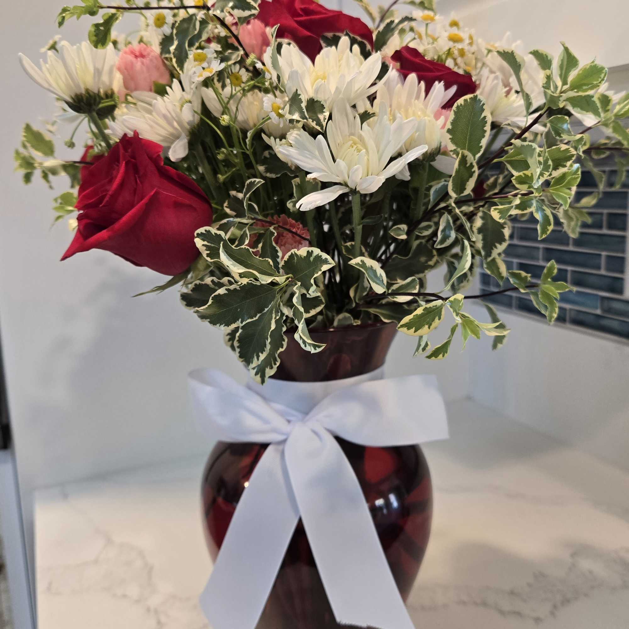 Filled with 14 stems of white, pink and red. Displayed in a