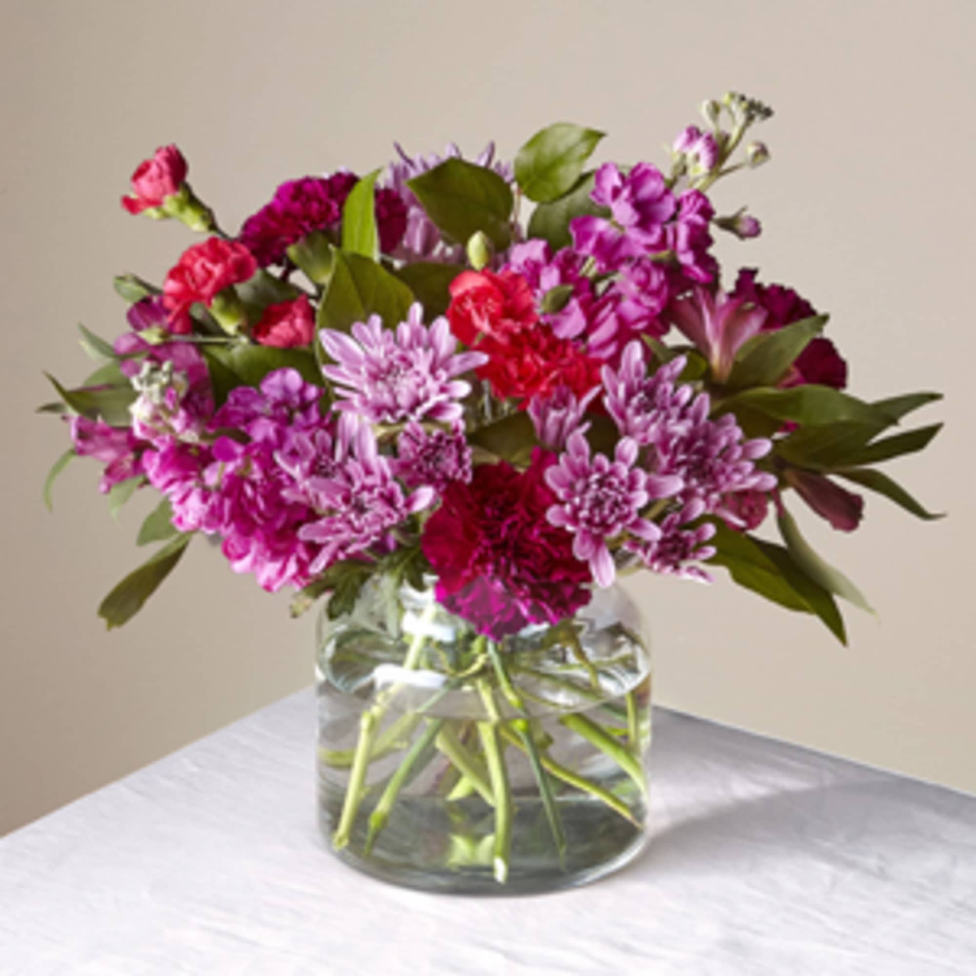 A sweet display of seasonal blooms in shades of pinks and purples A sweet display of seasonal blooms in shades of pinks and purples