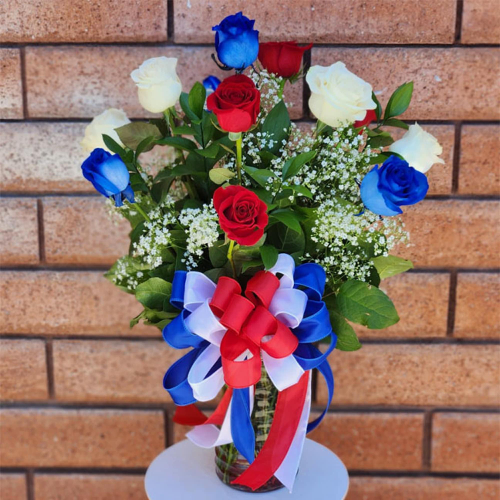 Stunning and inspirational, these long stem red, white, and blue roses are