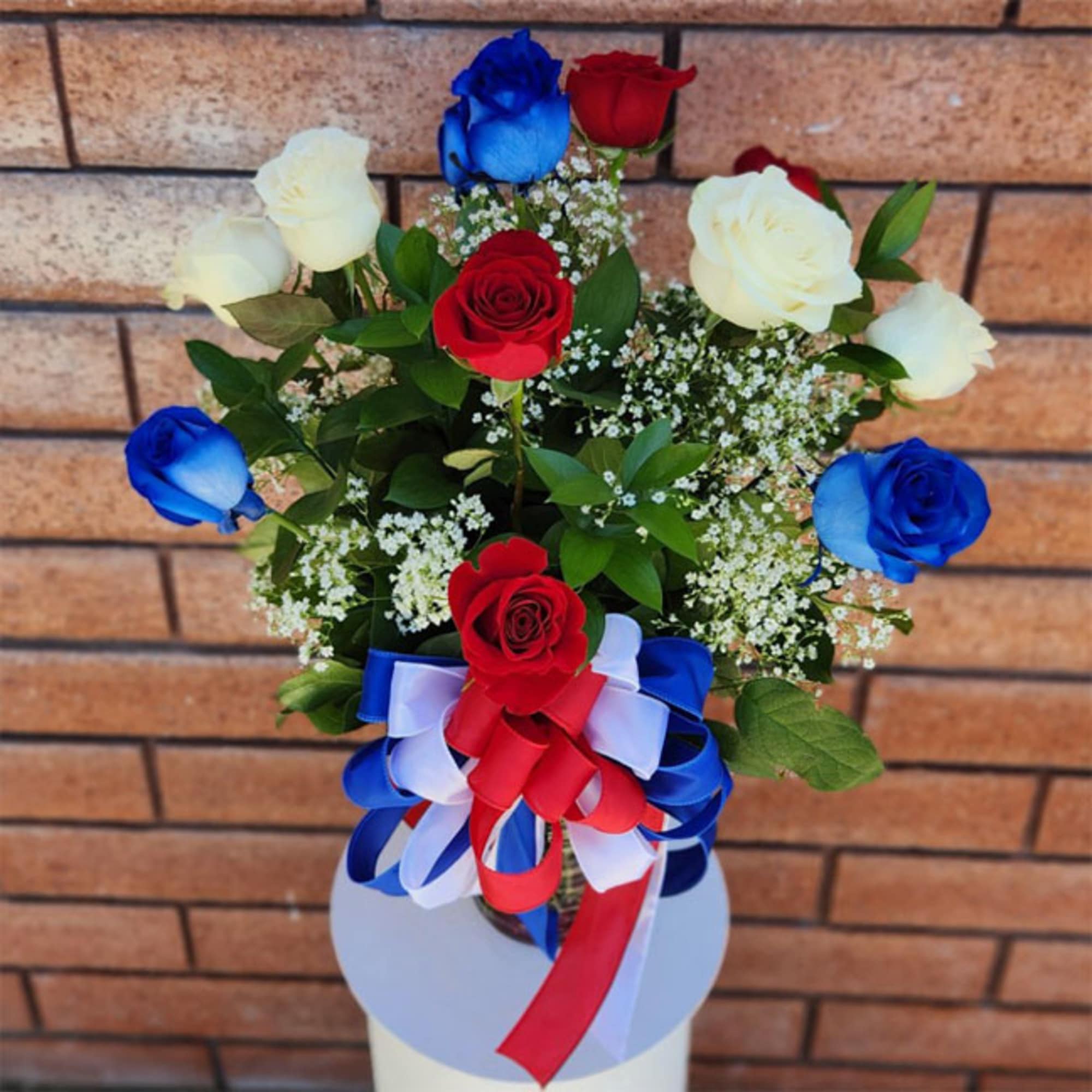 Stunning and inspirational, these long stem red, white, and blue roses are