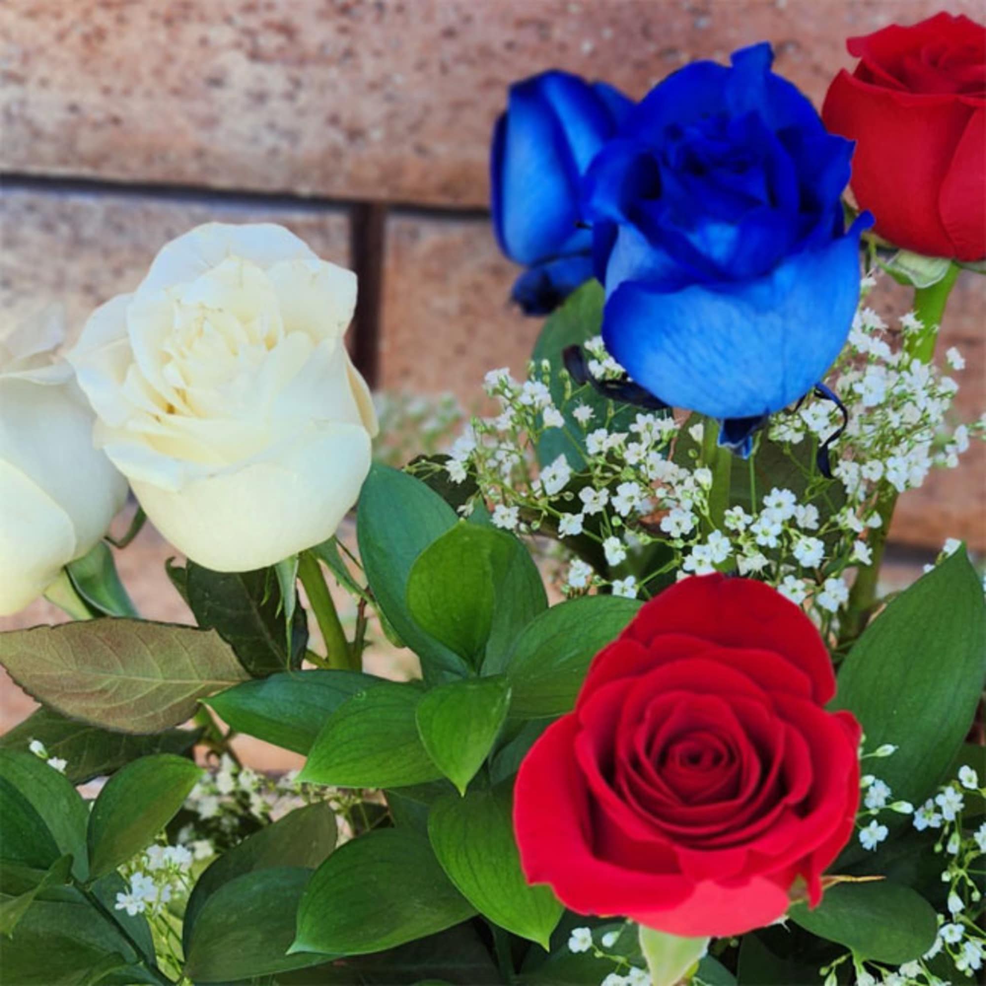 Stunning and inspirational, these long stem red, white, and blue roses are