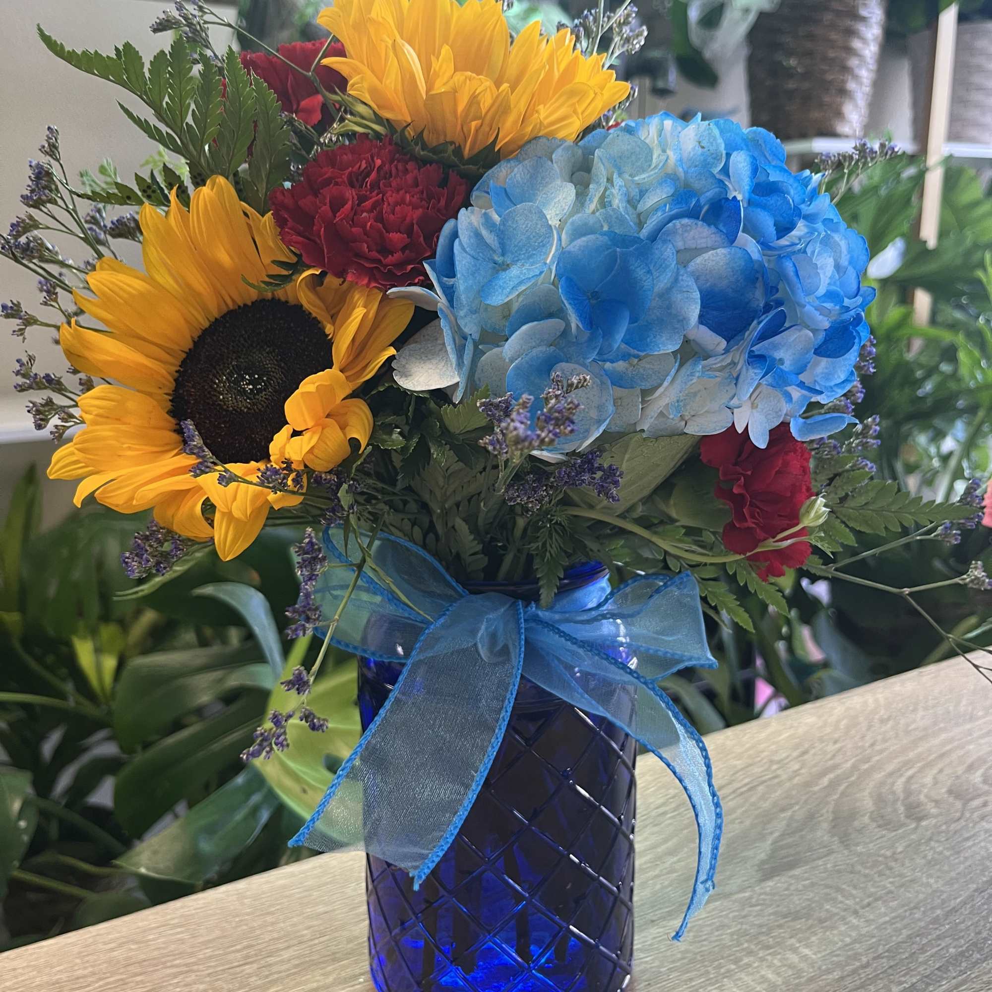 fresh sunflowers in blue vase 
