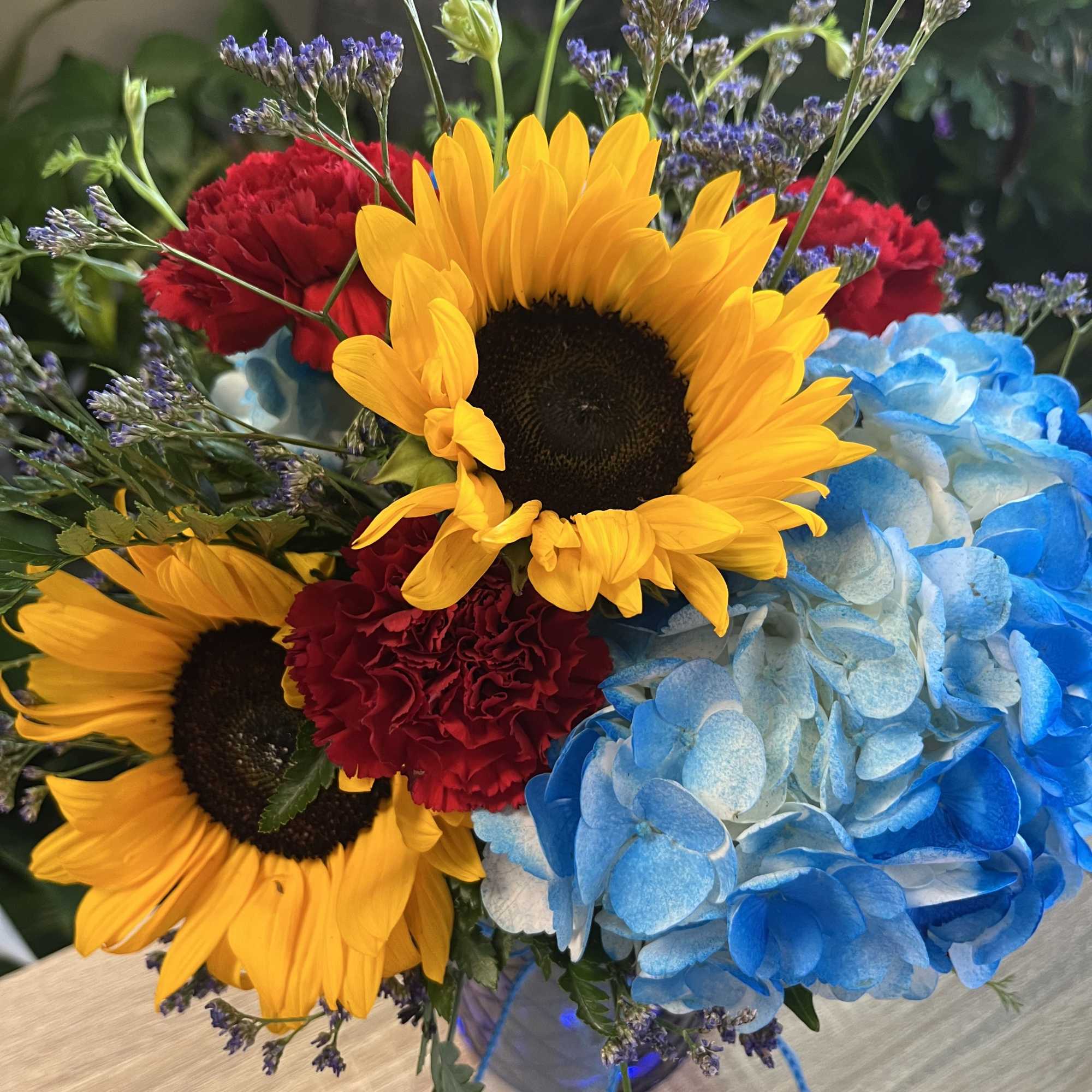 fresh sunflowers in blue vase 