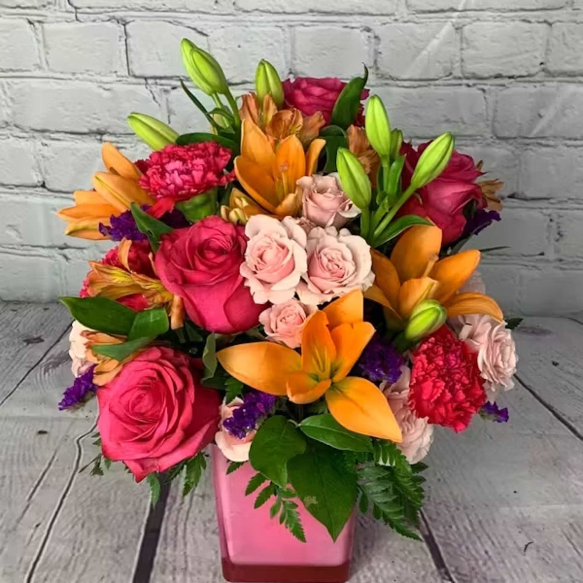 This fresh, fun mix of pink roses, peach asiatic lilies, peach alstroemeria