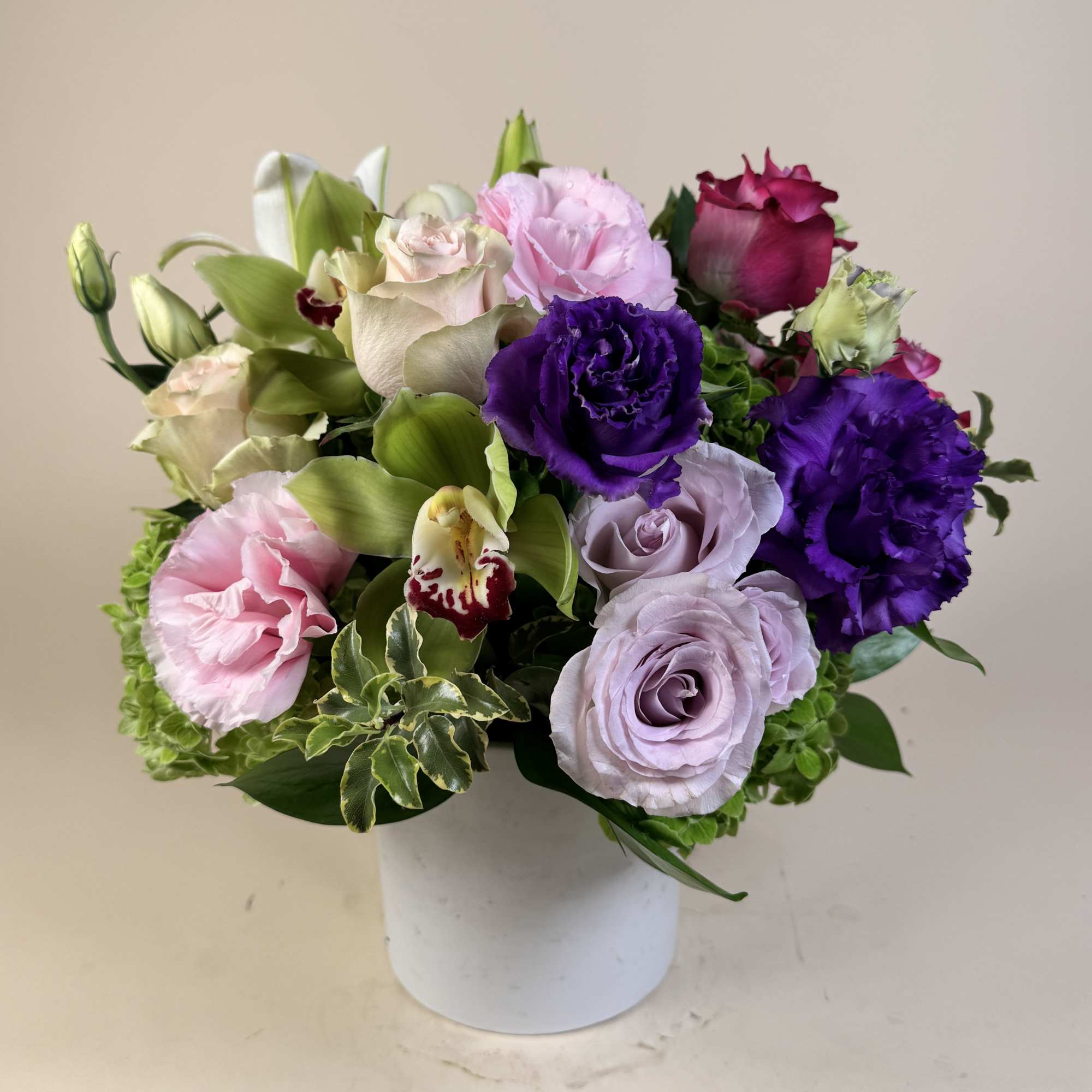 An adorable arrangement with lilies, roses, and hydrangea.