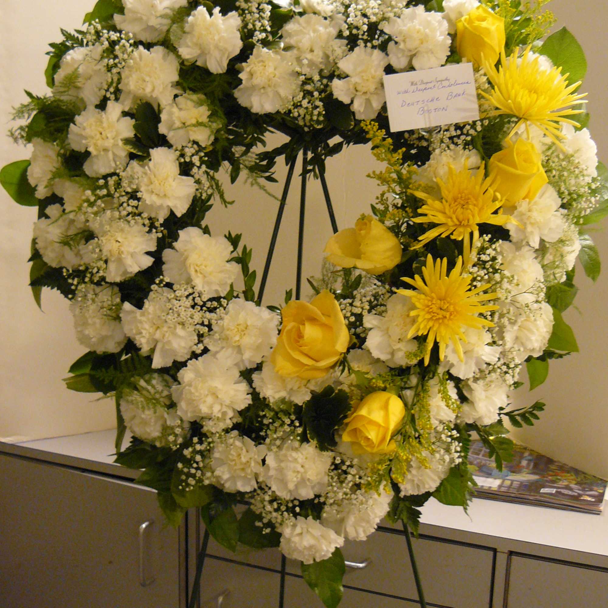 White Carnations, Yellow Roses, Fancy Assorted Greens. White Carnations, Yellow Roses, Fancy Assorted Greens.