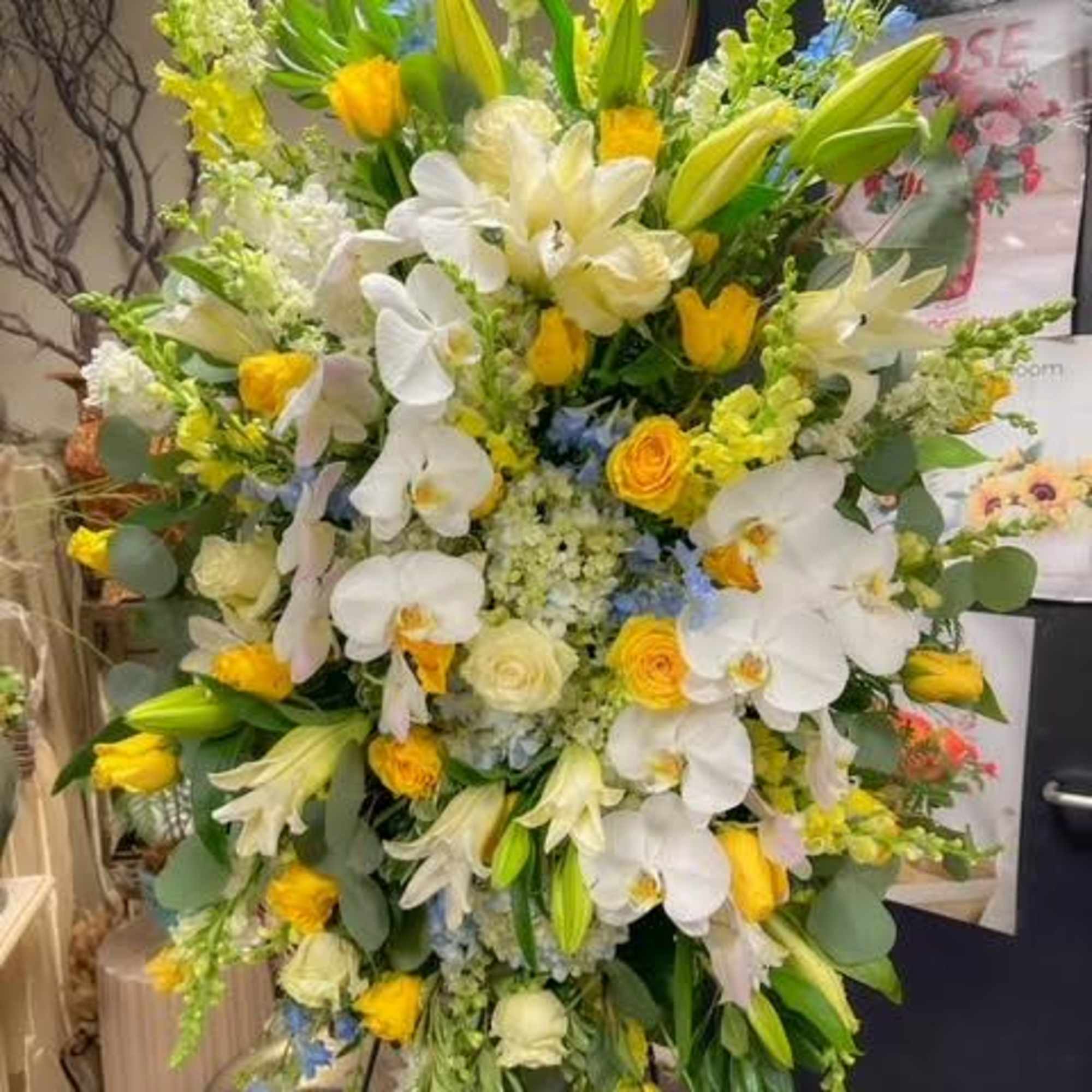The Serenity Bloom Standing Spray is a beautiful tribute to honor and