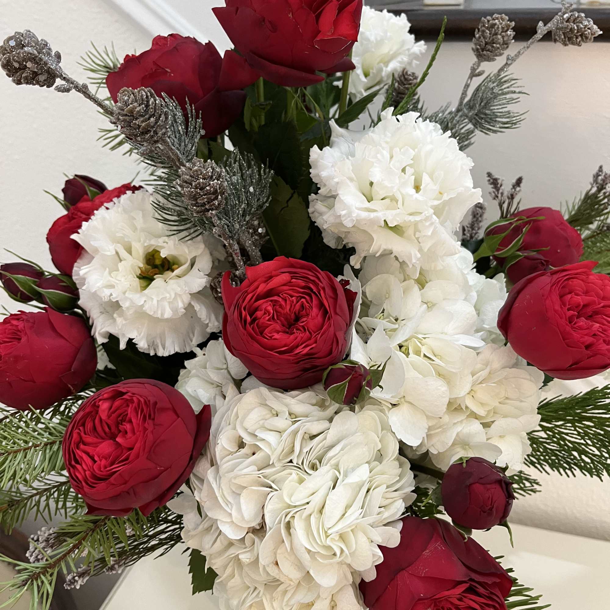Red garden roses, hydrangea, lisianthus in a beautiful crackled silver vase pre