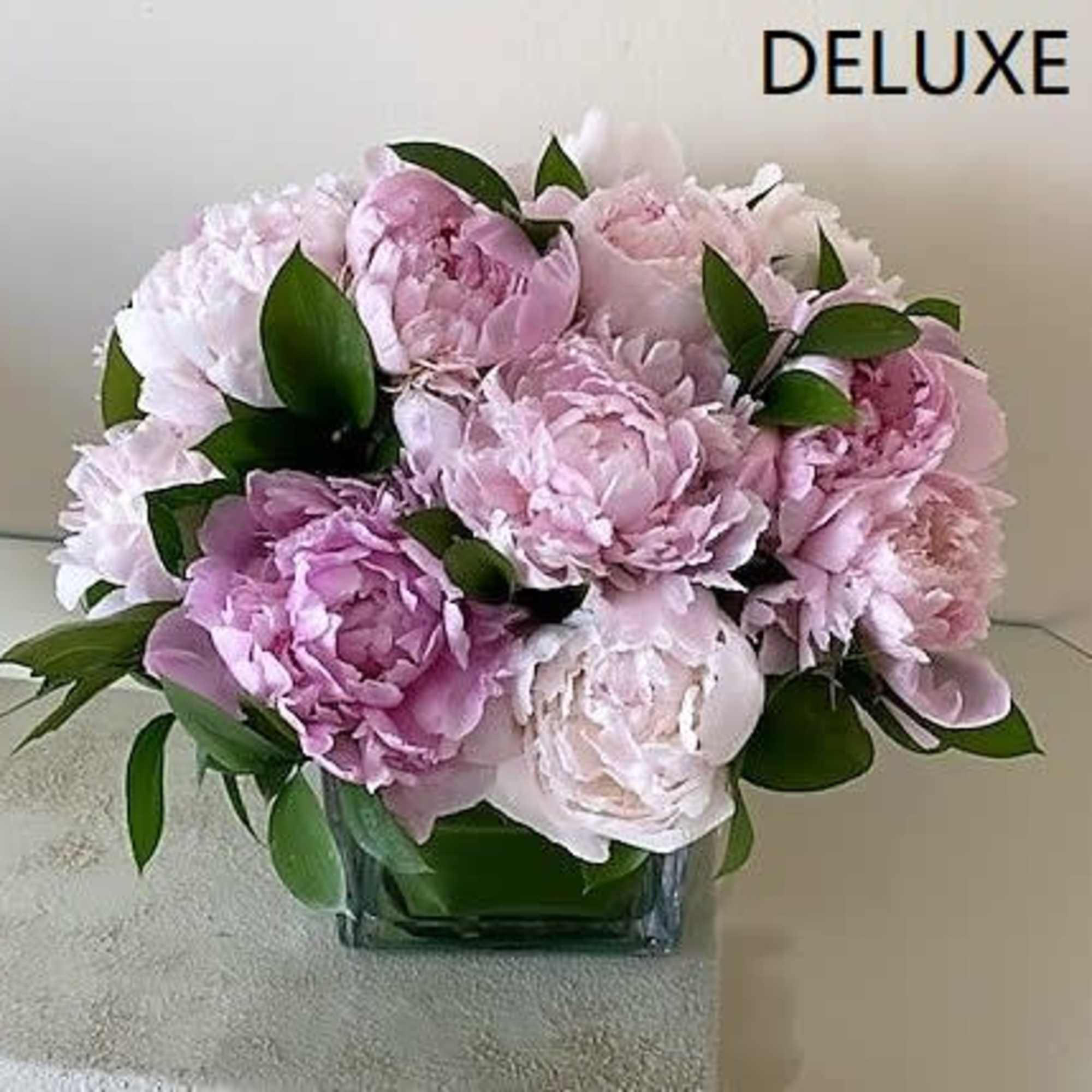 Peonies arranged in a glass vase vase with greenery.
Standard:  10 Peonies