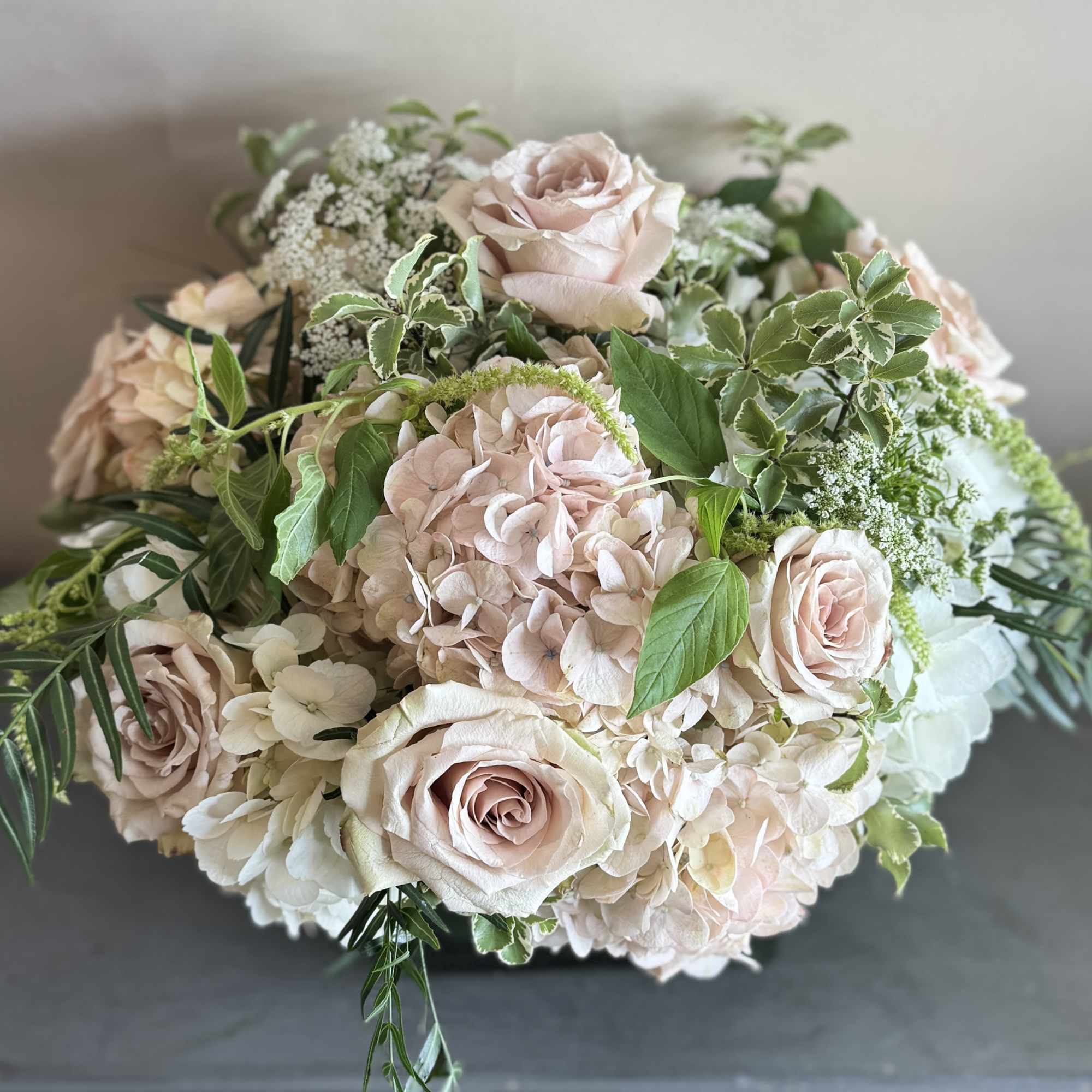 This stunning compact arrangement features a beautiful combination of muted pink roses