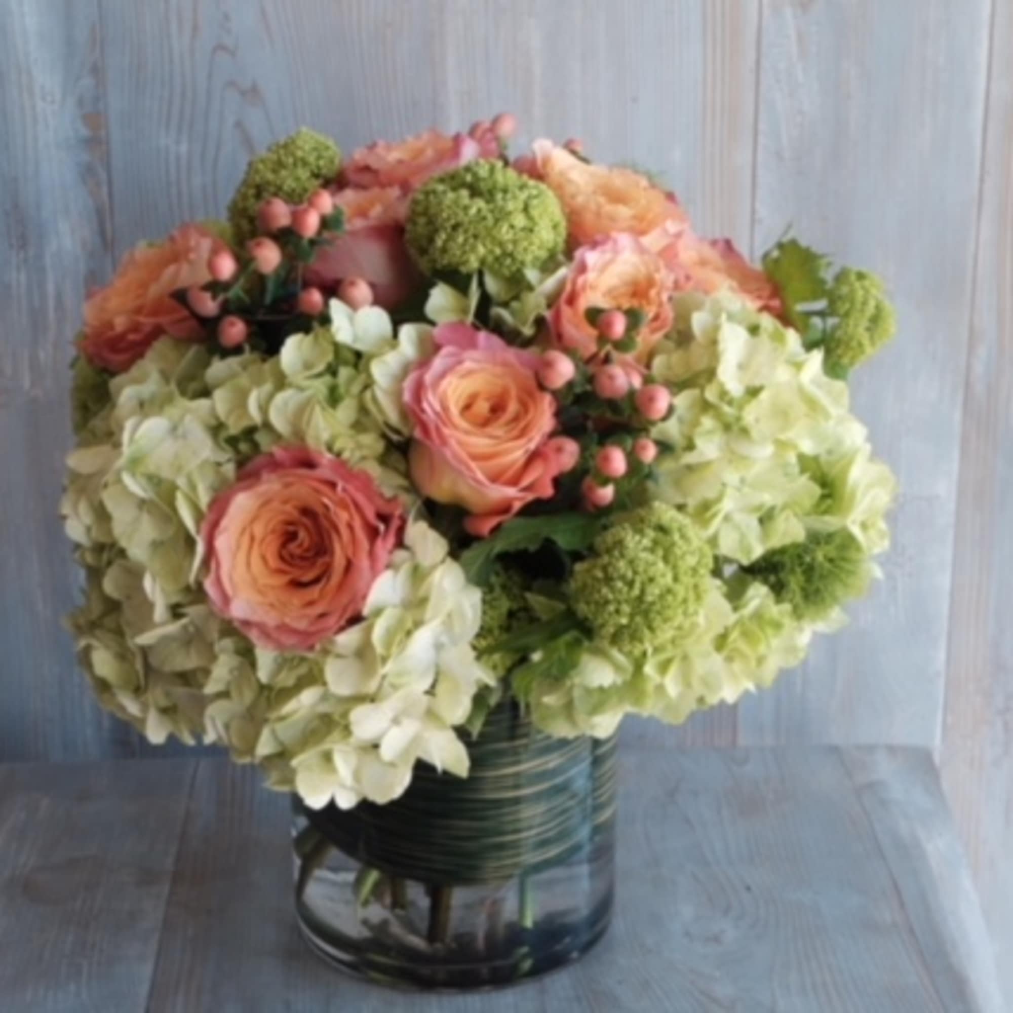 Indulge in the delightful beauty of peach roses and hydrangeas with our