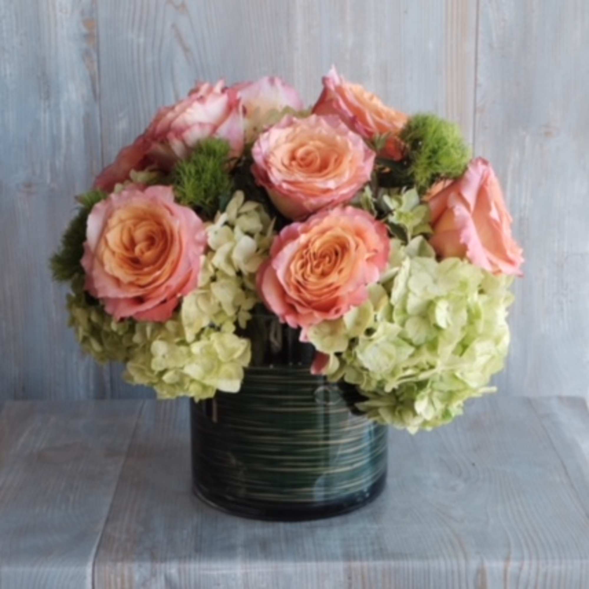 Indulge in the delightful beauty of peach roses and hydrangeas with our