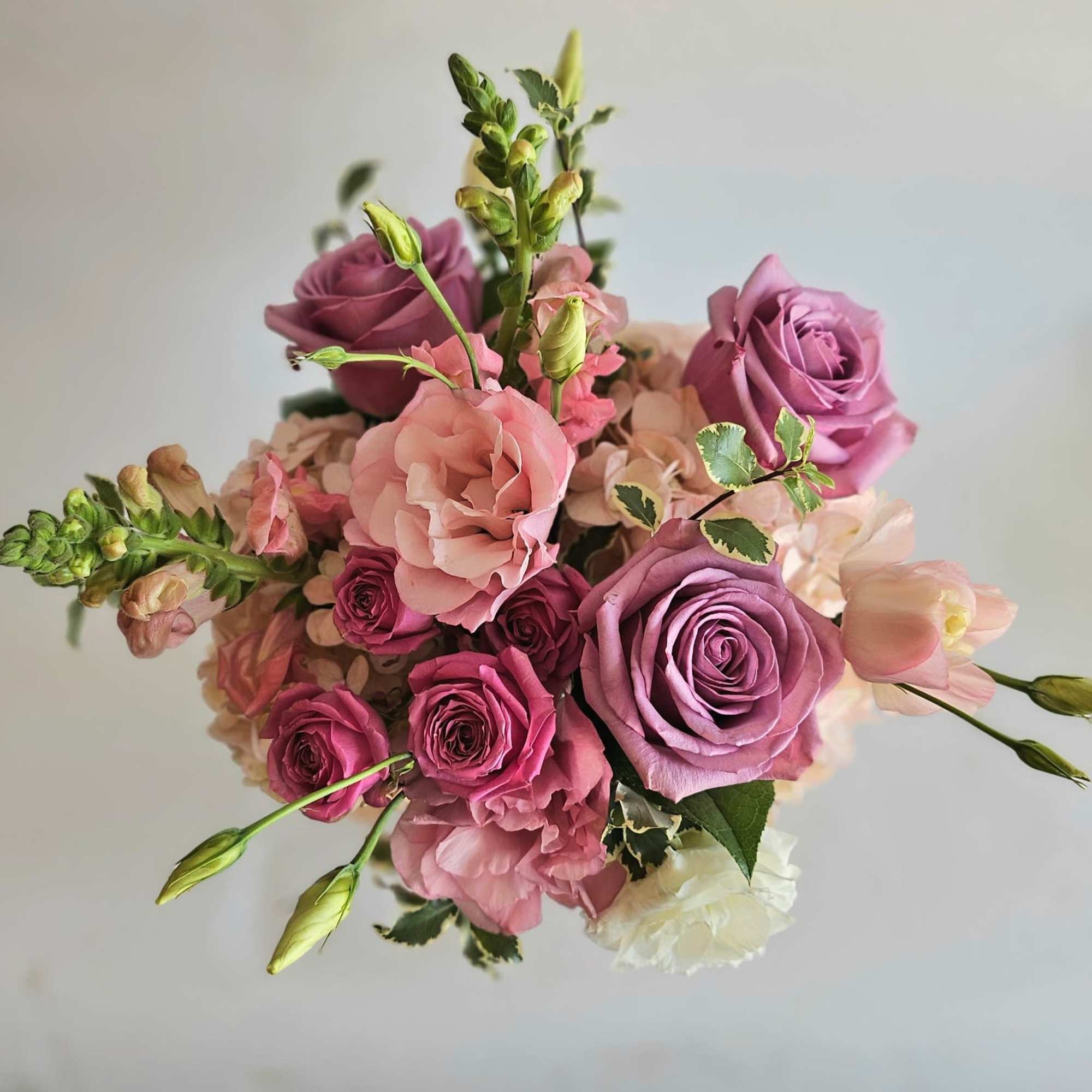 A stunning pink and lavender floral arrangement brimming with elegance and softness.