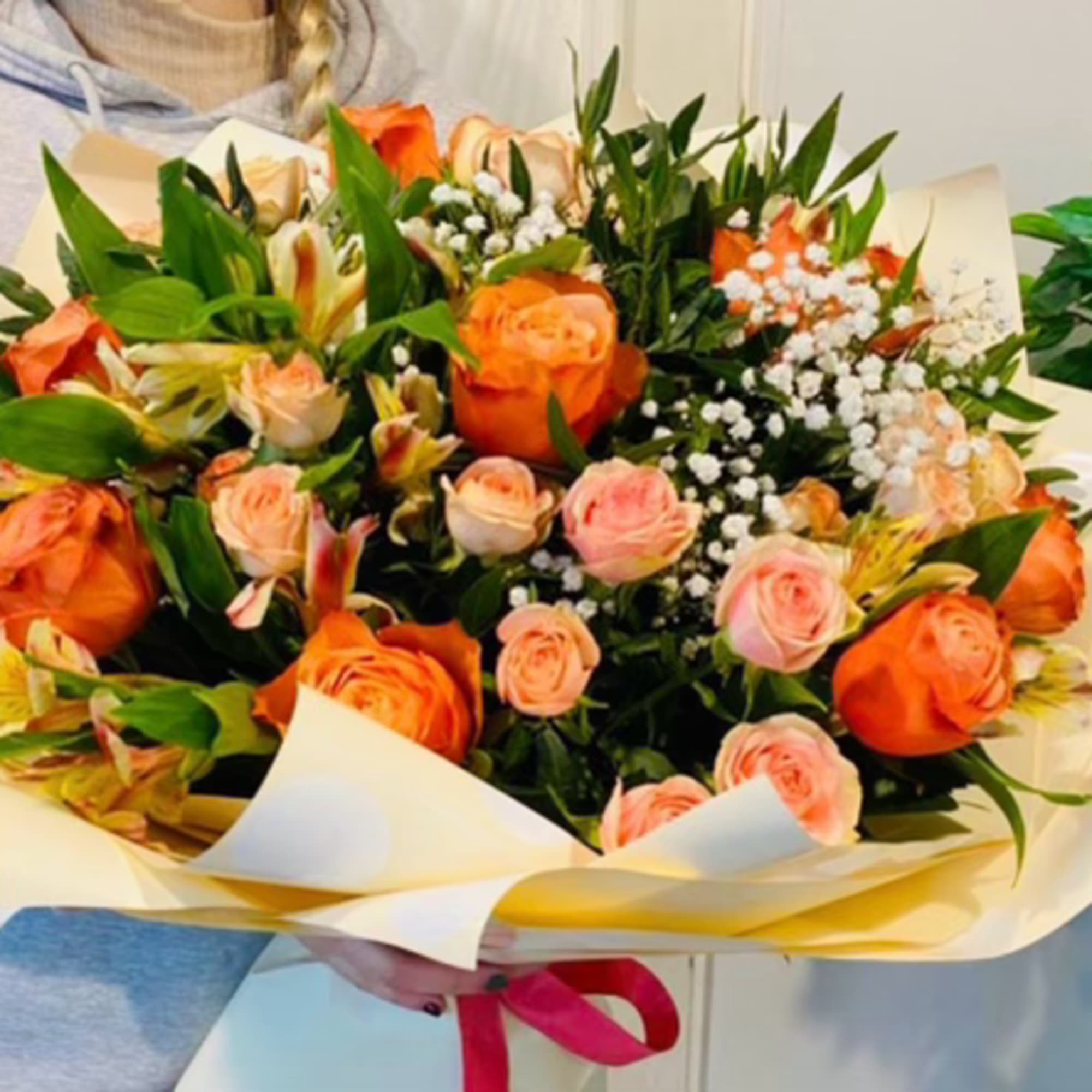 Delight in the elegance of this bouquet featuring vibrant orange roses, tender Delight in the elegance of this bouquet featuring vibrant orange roses, tender