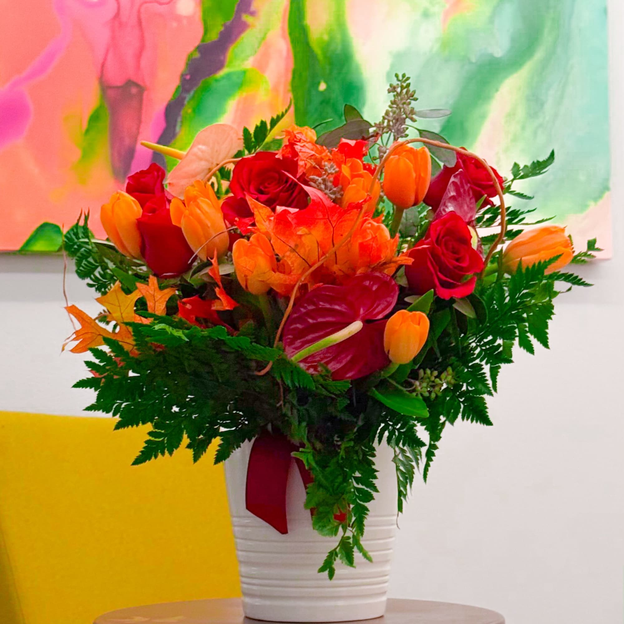 The “Fall Sunset” bouquet captures the vibrant beauty of autumn with red The “Fall Sunset” bouquet captures the vibrant beauty of autumn with red