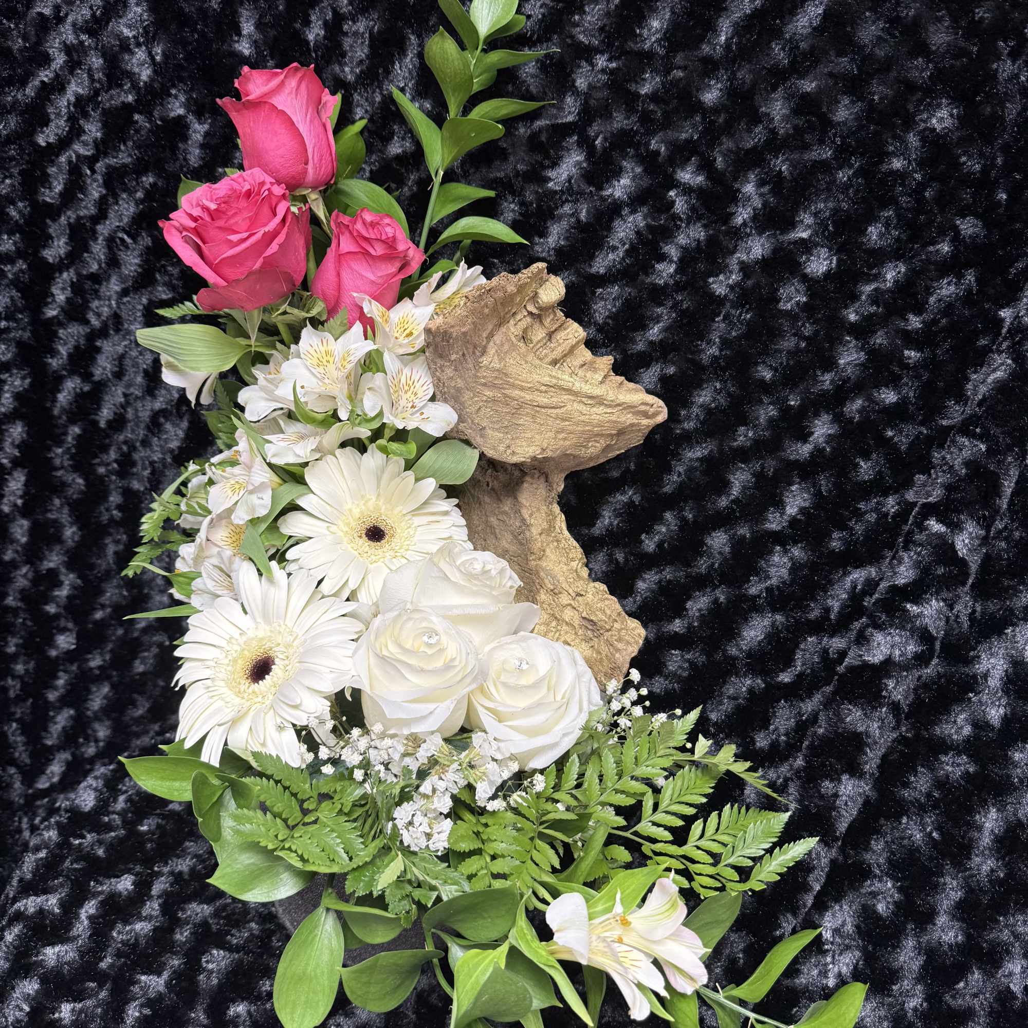 A serene and dreamy design. Soft roses rest around a golden trunk A serene and dreamy design. Soft roses rest around a golden trunk