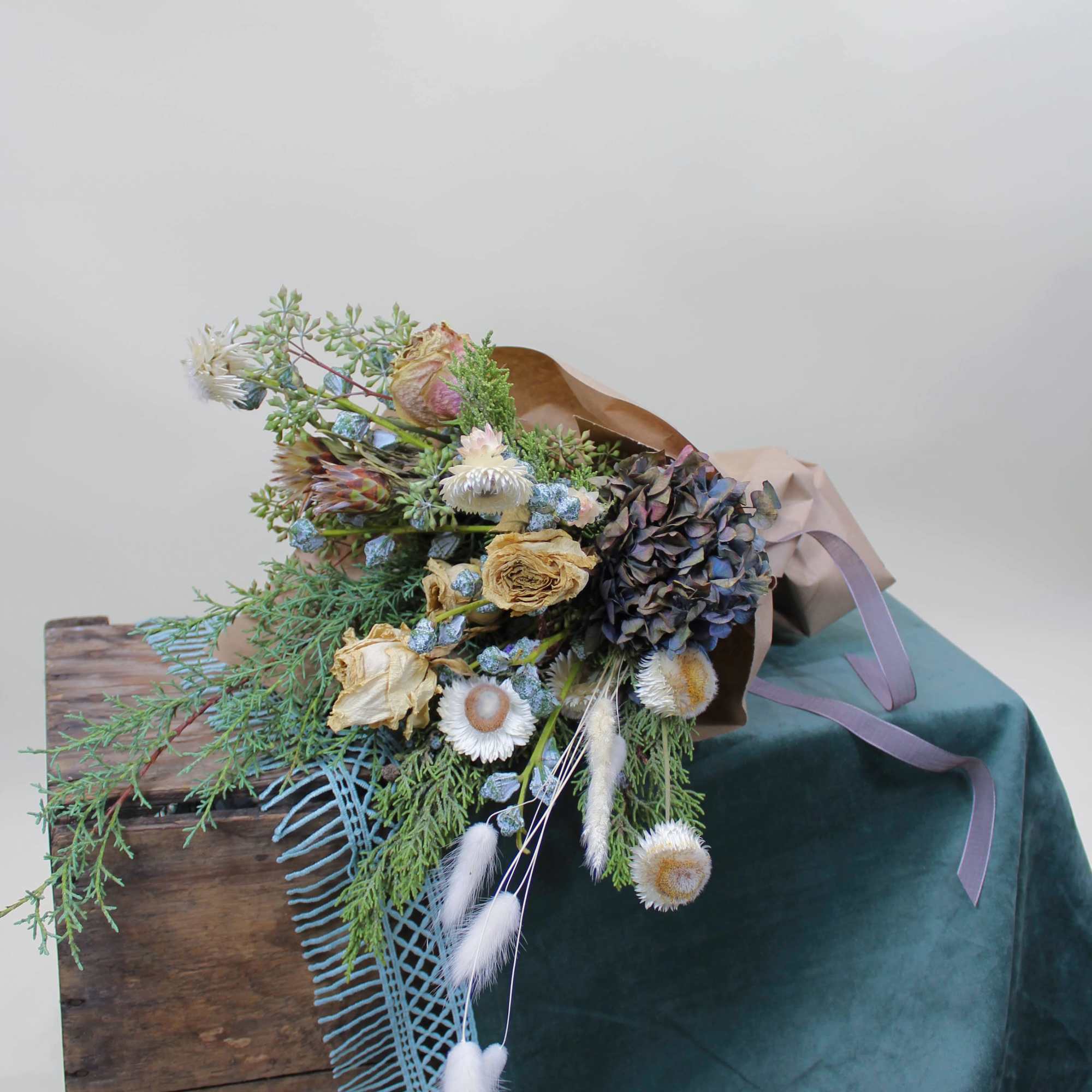 Dried botanical elements wrapped in paper with a beautiful ribbon to match.

*Images