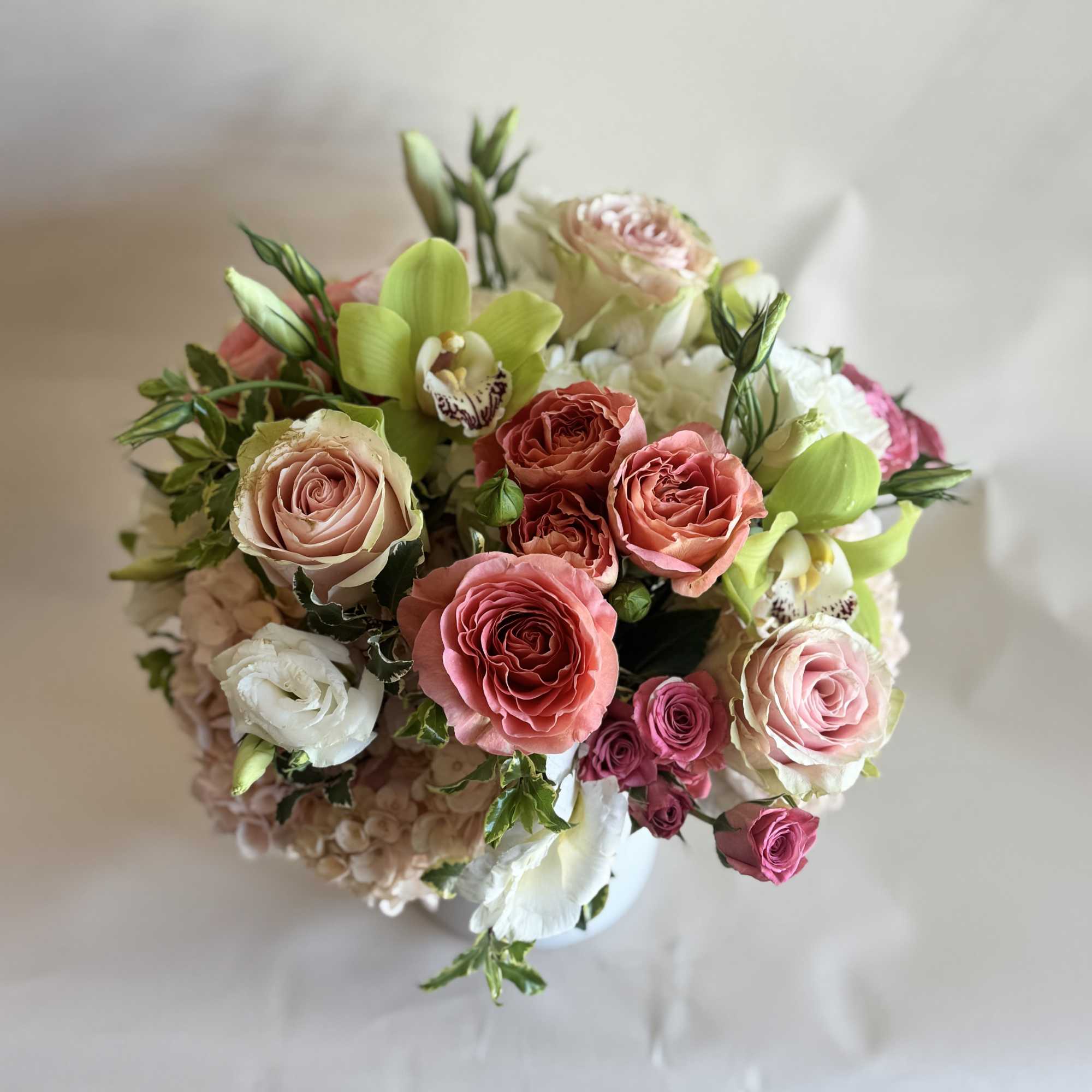 A fresh and elegant floral arrangement in a serene palette of green