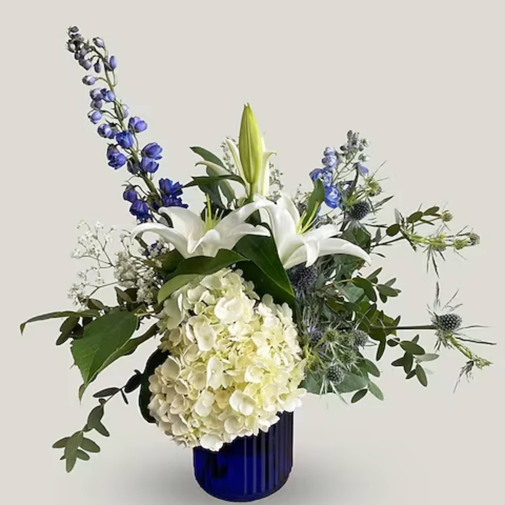 This lovely blue and white arrangement creates a statement to celebrate a This lovely blue and white arrangement creates a statement to celebrate a