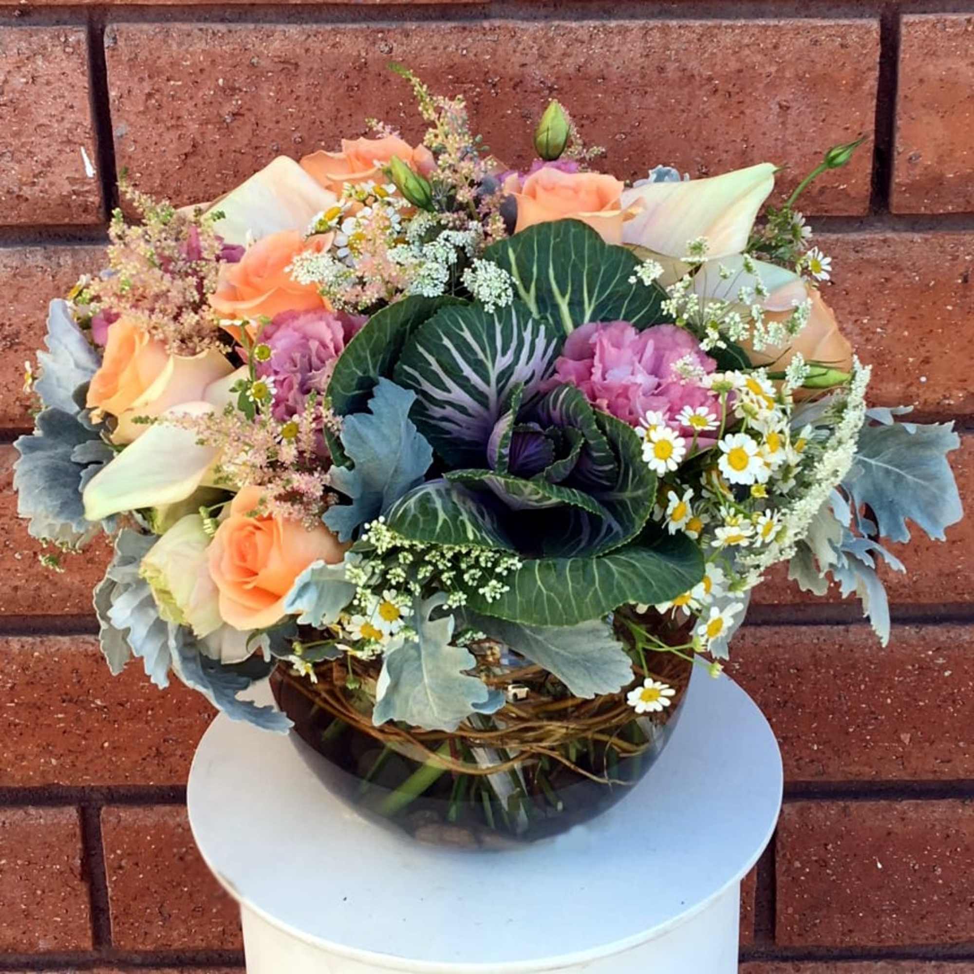 This beautiful arrangement features a soft and sweet collection of seasonal tones