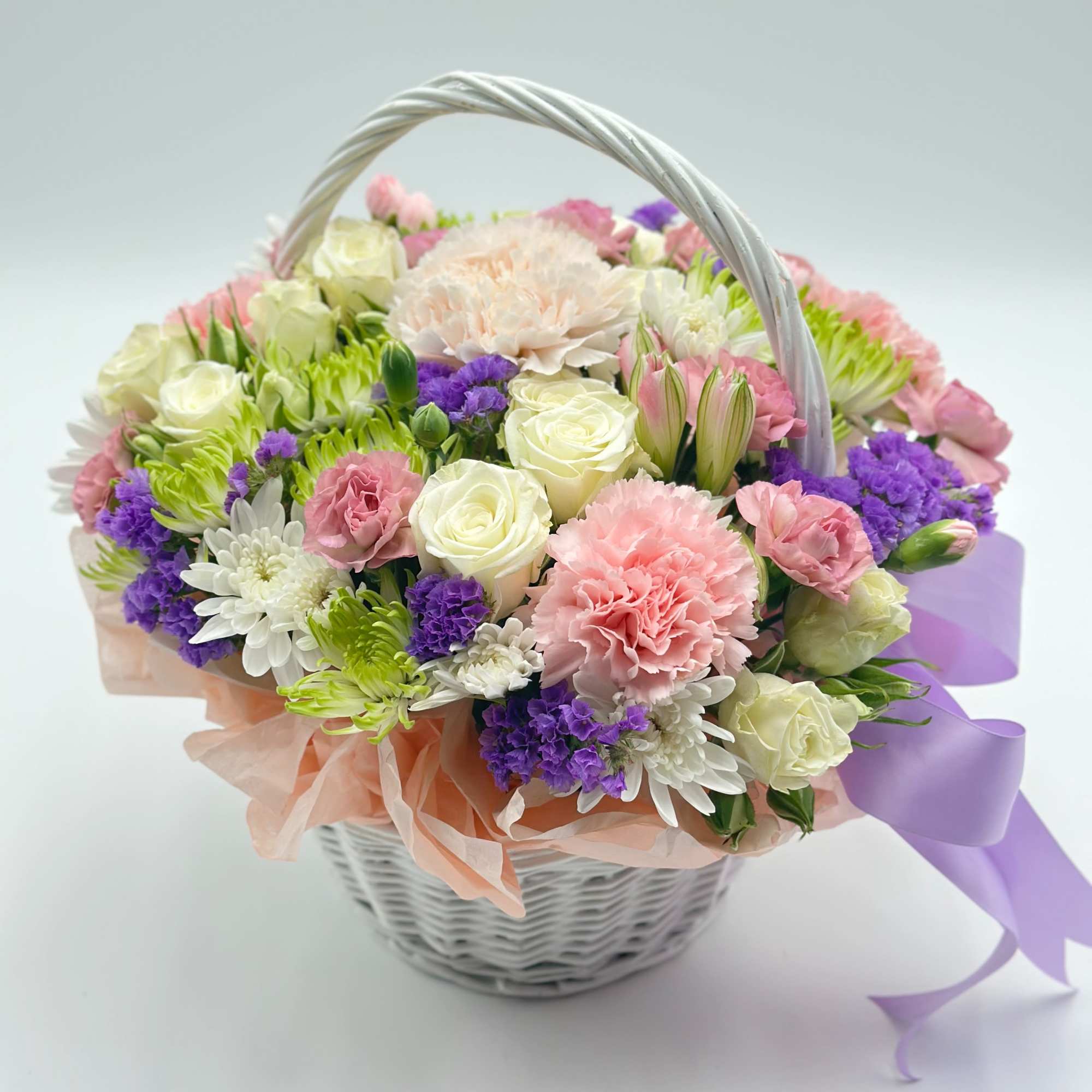A charming little flower basket made of fresh, delicate blooms — the A charming little flower basket made of fresh, delicate blooms — the