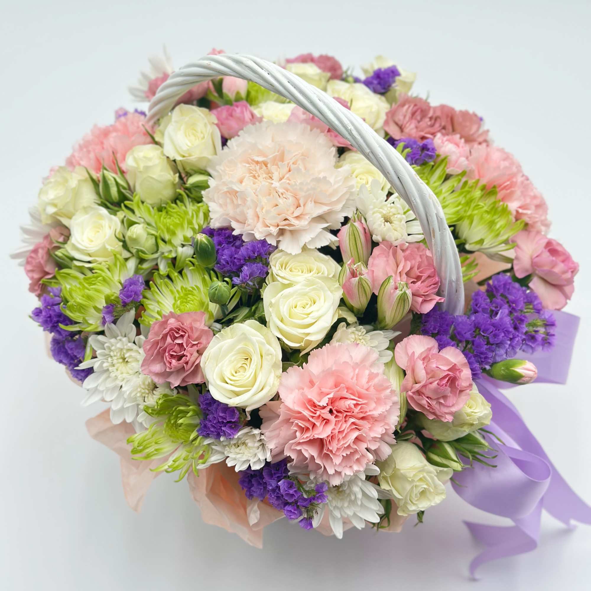 A charming little flower basket made of fresh, delicate blooms — the A charming little flower basket made of fresh, delicate blooms — the